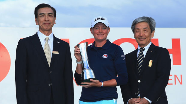 Stacy Lewis of the poses with the trophy and Zenji Miura and Simon Sasaki