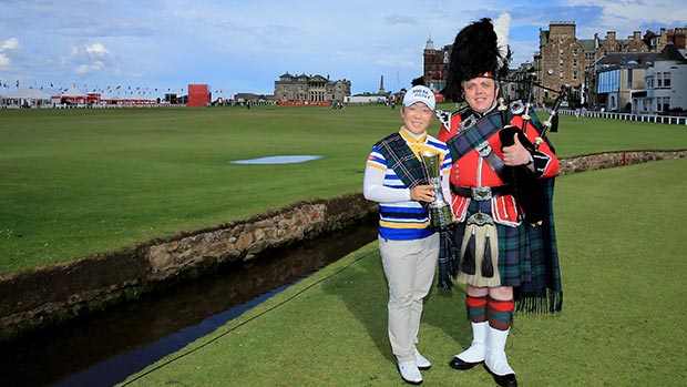 Jiyai Shin poses with a piper on the 18th hole as a preview for the 2013 Ricoh Women's British Open