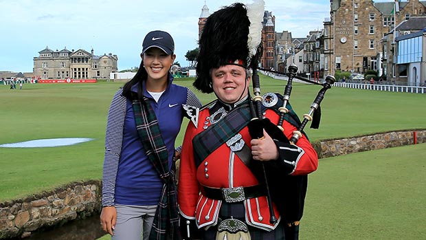 Michelle Wie poses with a piper on the 18th hole as a preview for the 2013 Ricoh Women's British Open