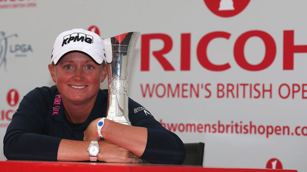 Stacy Lewis poses with the trophy at a press conference 