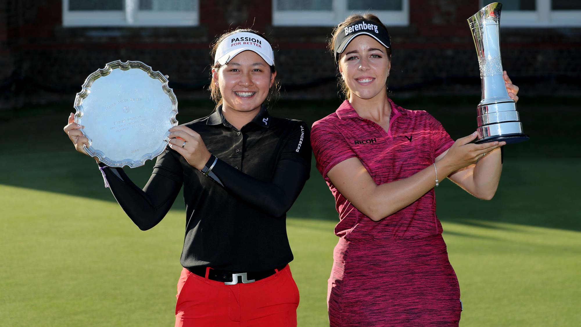 Georgia Hall of England holds the trophy after her victory with Atthaya Thitikul of Thailand the winner of the low amateur award in the final round of the Ricoh Women's British Open at Royal Lytham and St Annes Golf Club on August 5, 2018 in Lytham St Annes, England.