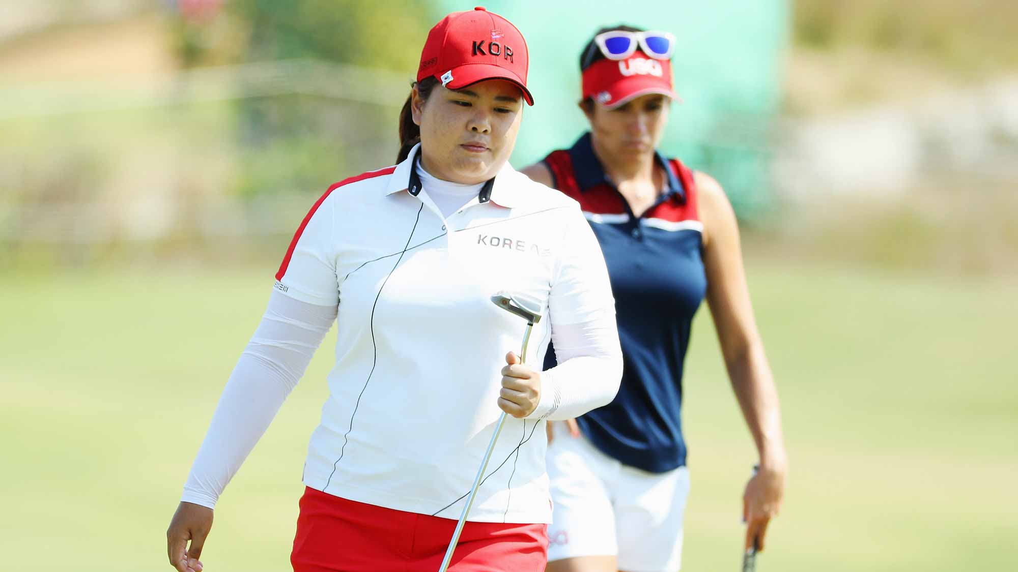 Inbee Park of Korea (L) and Gerina Piller of the United States wait on the seventh green during the second round of the Women's Individual Stroke Play golf on Day 13 of the Rio 2016 Olympic Games at Olympic Golf Course 