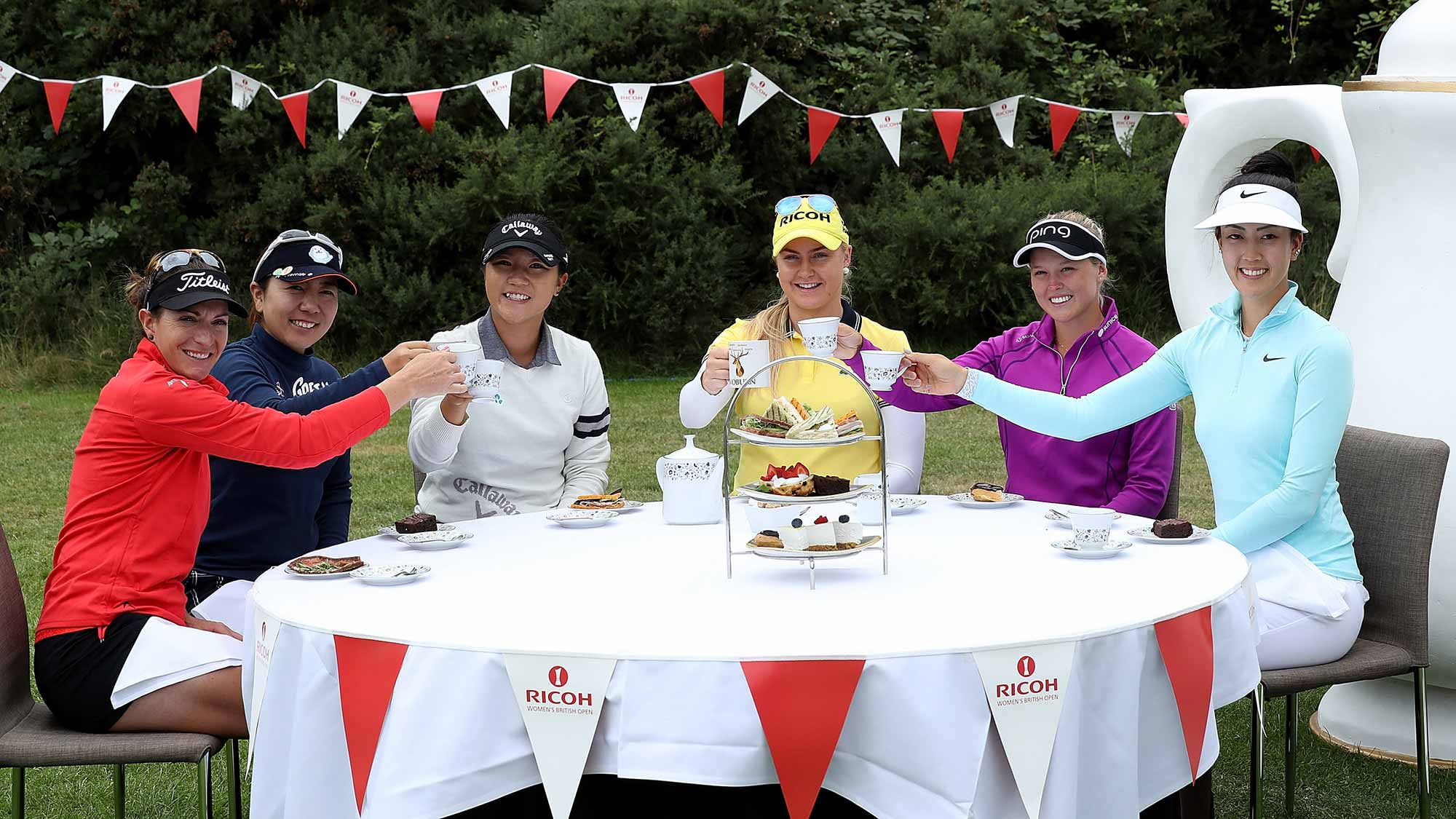 Charley Hull of England hosts a traditional English tea party for her fellow golfers at a photocall held at her home club, Woburn GC, (L-R) Brittany Lang of the United States, Mika Miyazato of Japan, Lydia Ko of New Zealand, Charley Hull of England, Brooke Henderson of Canada and Michelle Wie of the United States, during a Pro-Am round ahead of the Ricoh Women's British Open