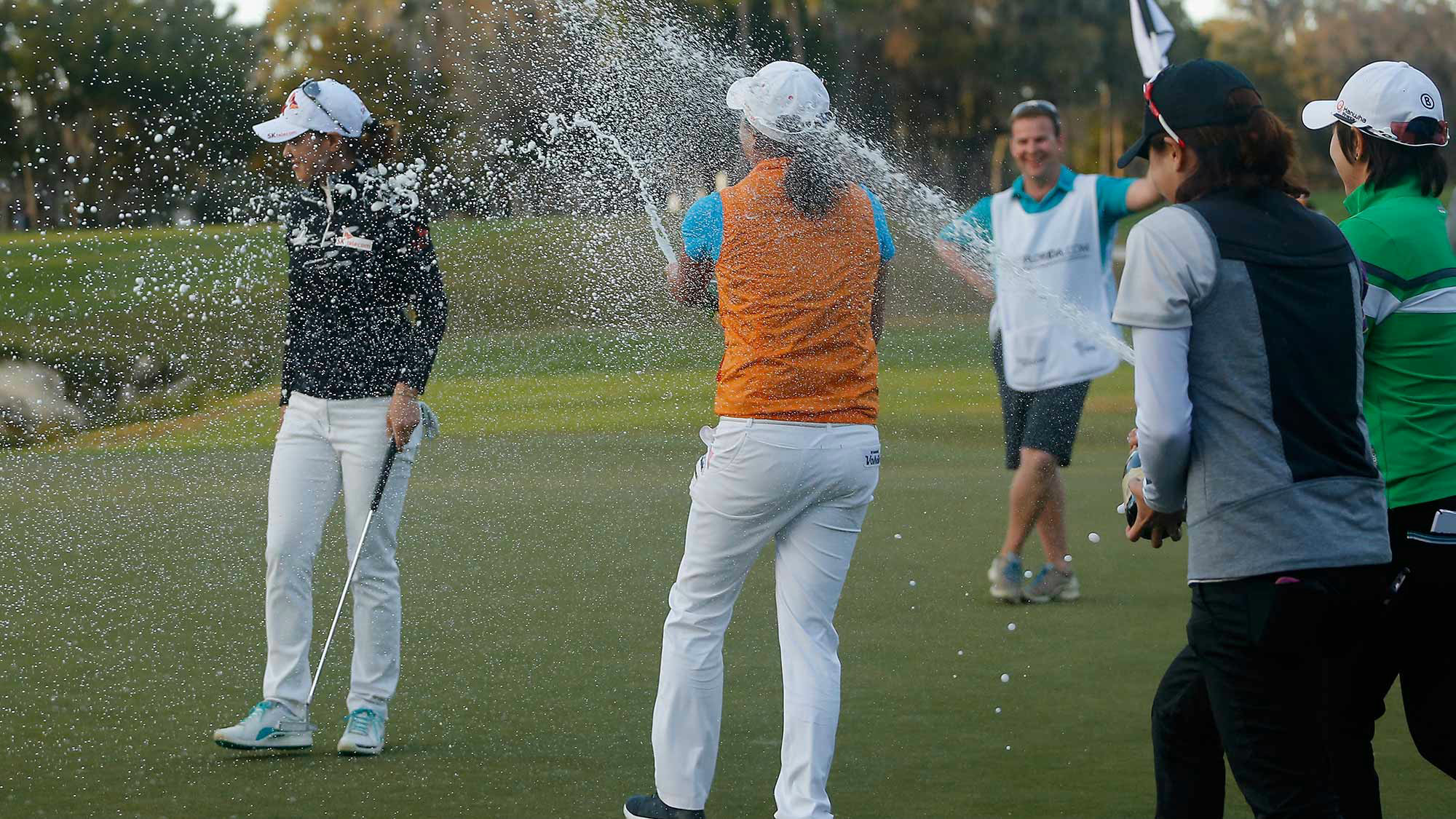 Na Yeon Choi of South Korea is sprayed with champagne by LPGA players on the 18th green following her victory at the Coates Golf Championship