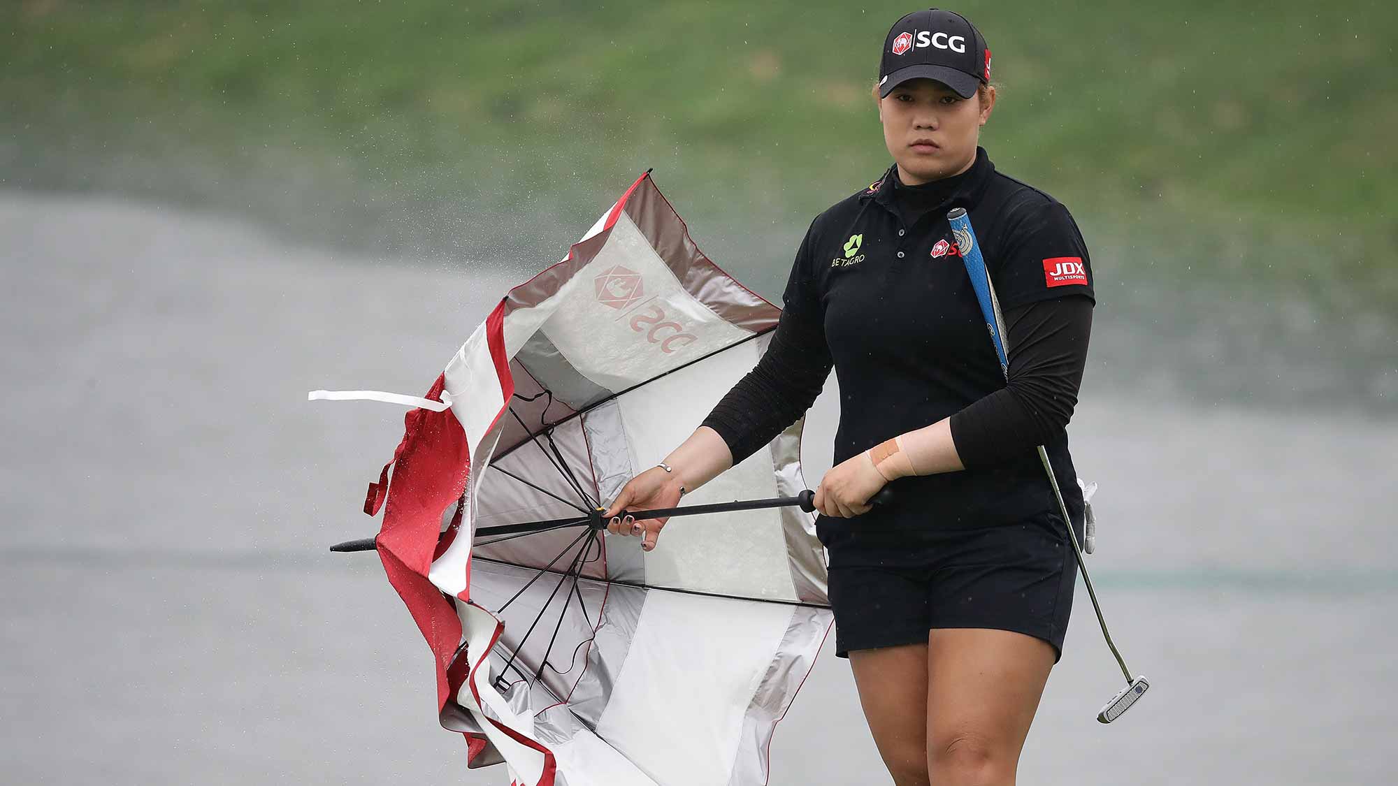 Ariya Jutanugarn of Thailand wear black clothing to mourn the death of King Bhumibol on the 18th green during the final round of the LPGA KEB-Hana Bank Championship at the Sky 72 Golf Club Ocean Course