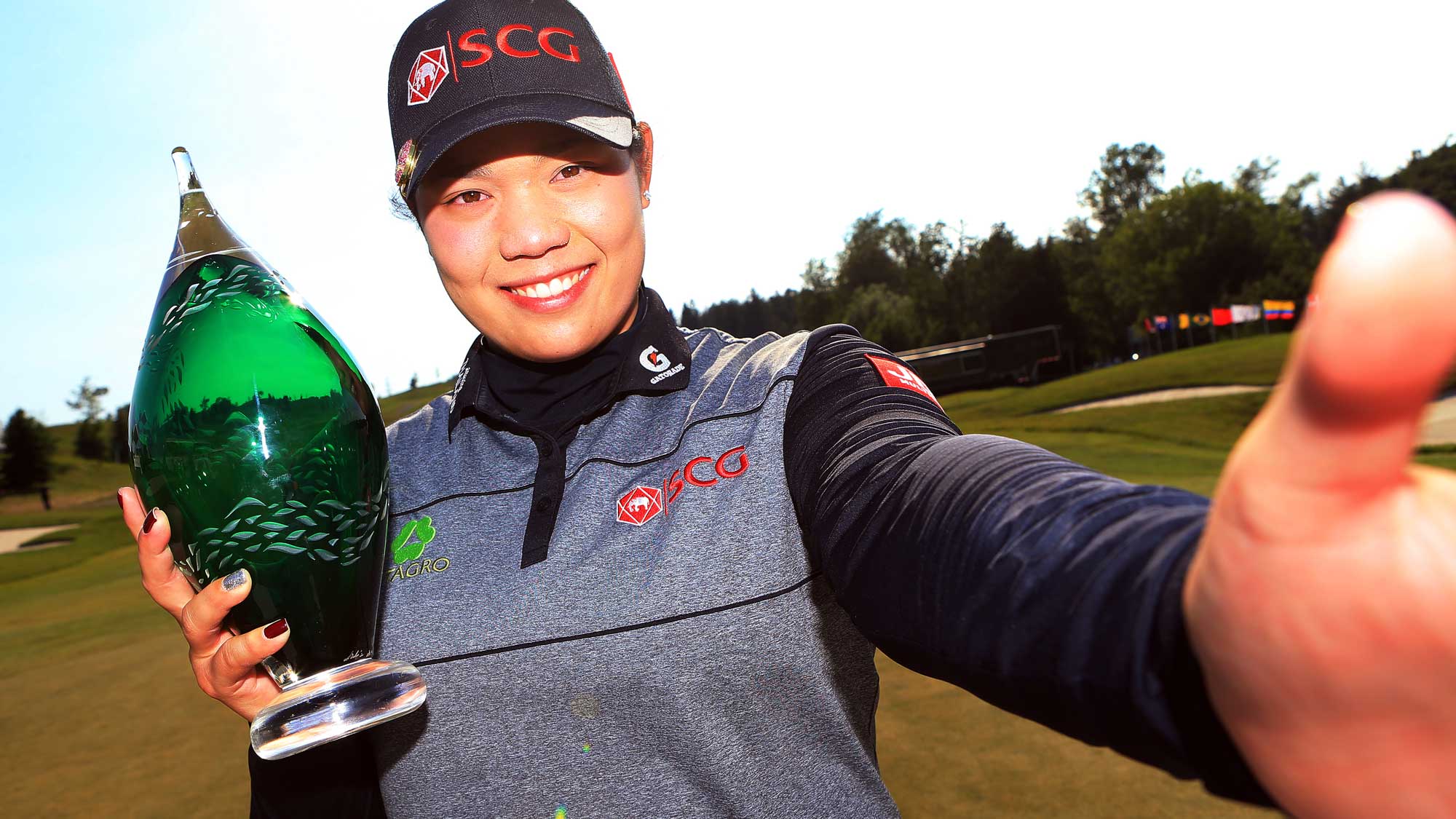 Ariya Jutanugarn of Thailand imitates a 'selfie' after sinking her birdie putt on the 1st playoff hole to win during the final round of the Manulife LPGA Classic