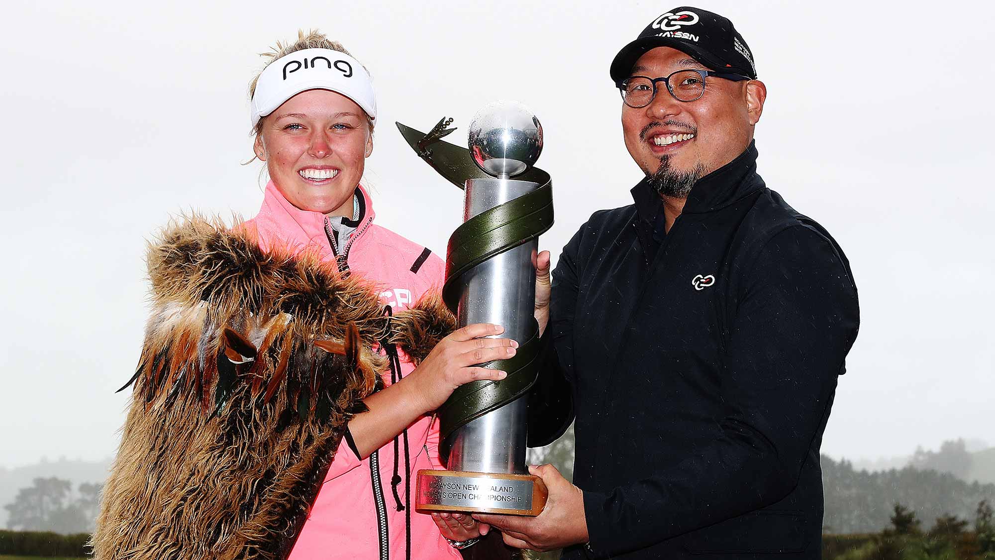 Brooke Henderson of Canada is presented the New Zealand Women's Open trophy by MC Kim during day five of the New Zealand Women's Open at Windross Farm