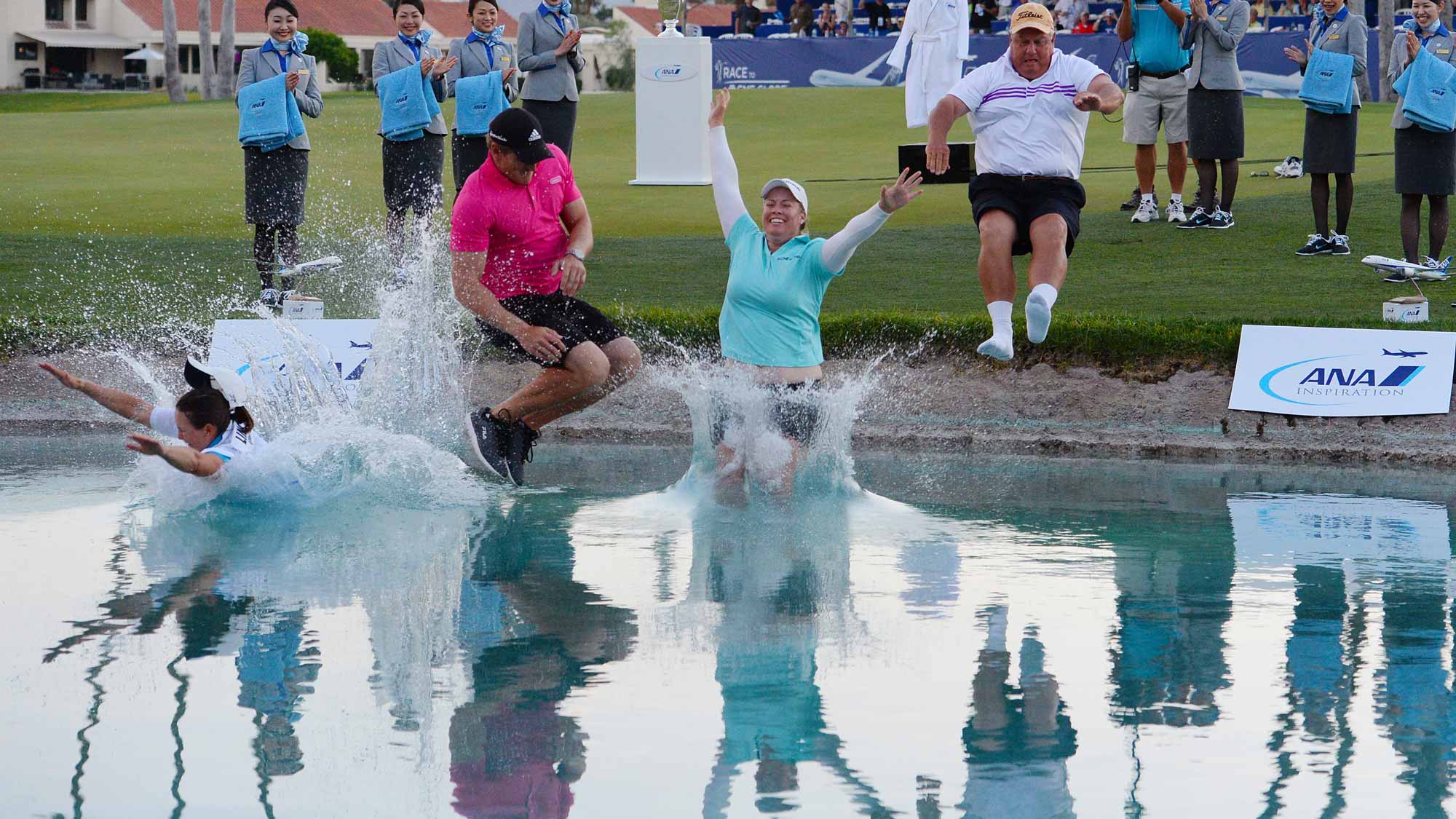 Brittany Lincicome jumps in the water with from left to right, her caddie Missy Pederson, her fiance Dewald Gouws and her father Tom Lincicome after winning the ANA Inspiration