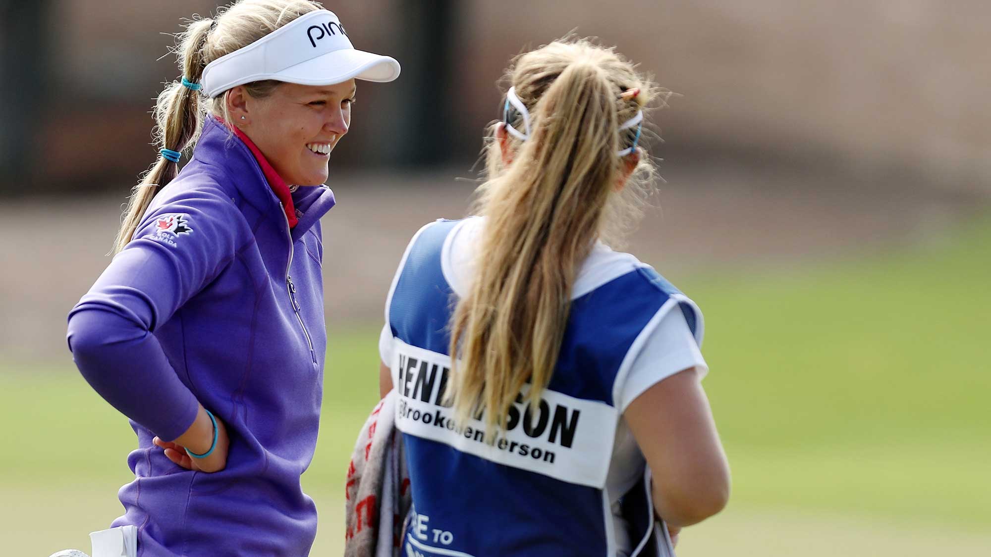 Brooke Henderson of Canada talks with her caddie on the 11th hole during the second round of the CME Group Tour Championship at Tiburon Golf Club