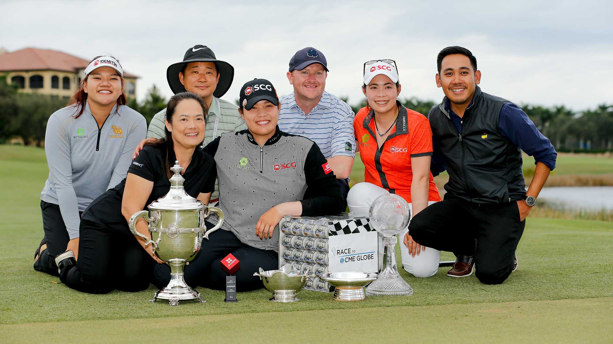 Ariya Jutanugarn of Thailand and her family pose for a photo with (left to right) the Rolex Player of the Year trophy, Leaders Top 10 Competition Trophy, Vare trophy, Rolex Annika Major award and the Race to the CME Globe trophy after the final round of the LPGA CME Group Tour Championship