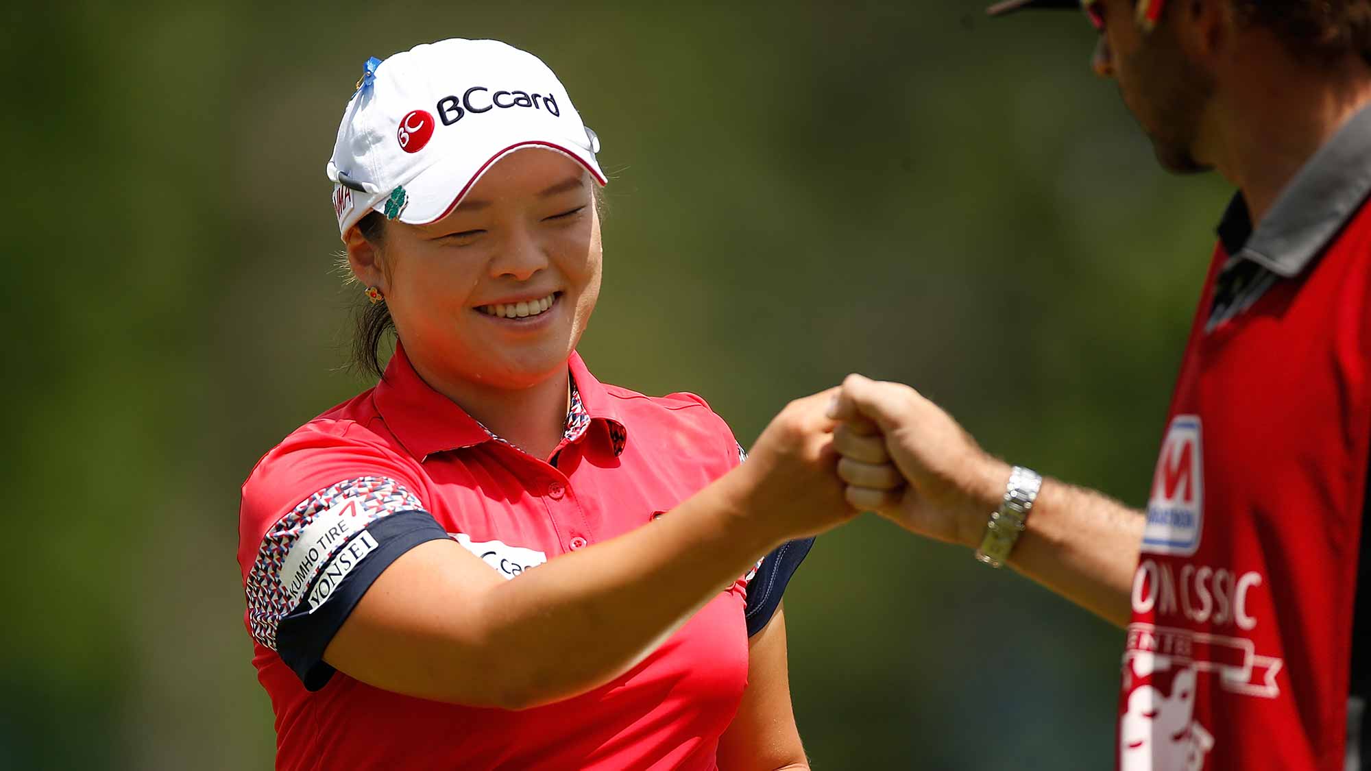Ha Na Jang of South Korea celebrates a par save with her caddie David Stone on the first green during the third round of the Marathon Classic presented by Owens Corning and O-I at Highland Meadows Golf Club
