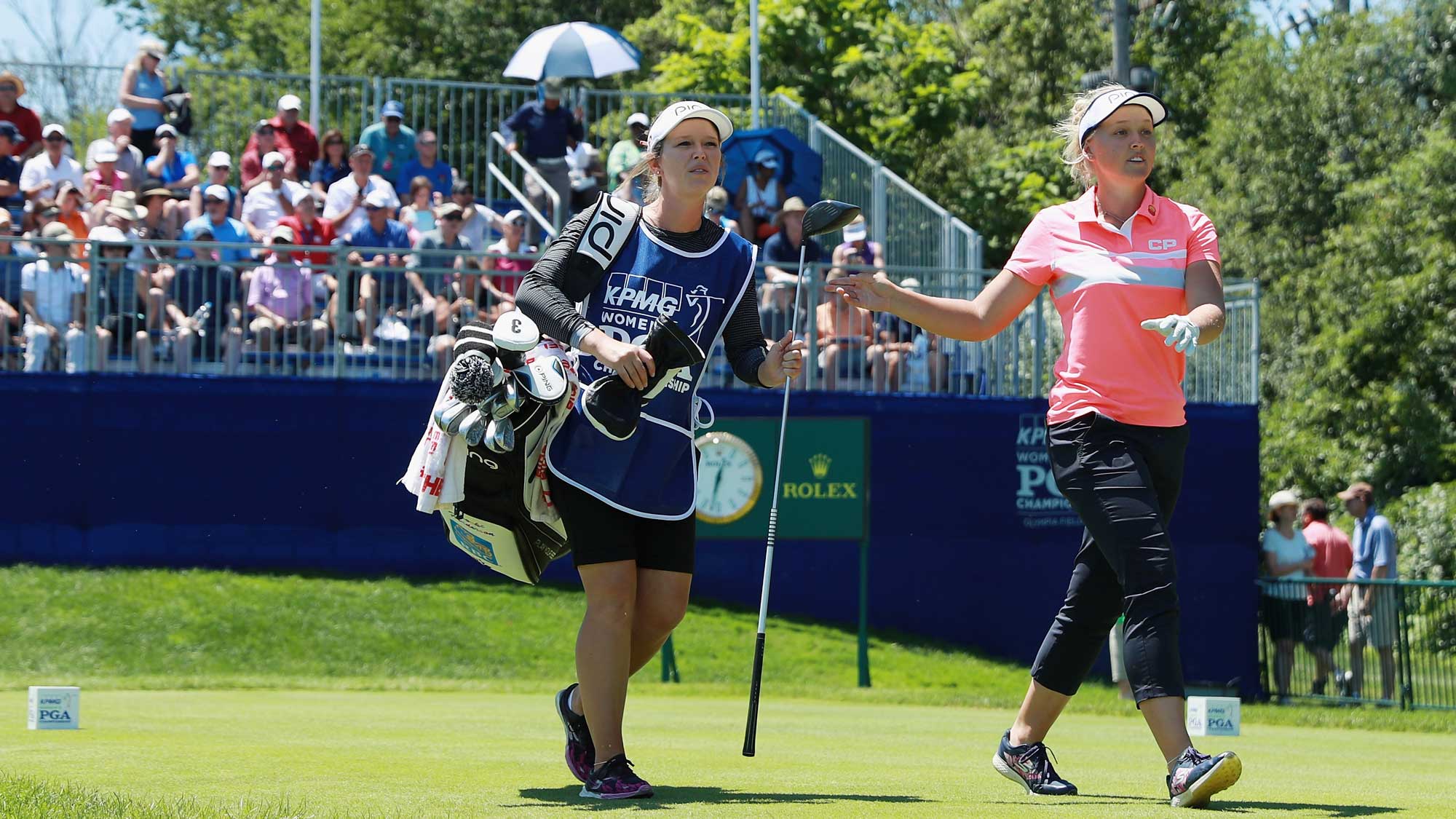 Brooke Henderson of Canada walks off the first tee alongside her sister/caddie Brittany during the final round of the 2017 KPMG Women's PGA Championship