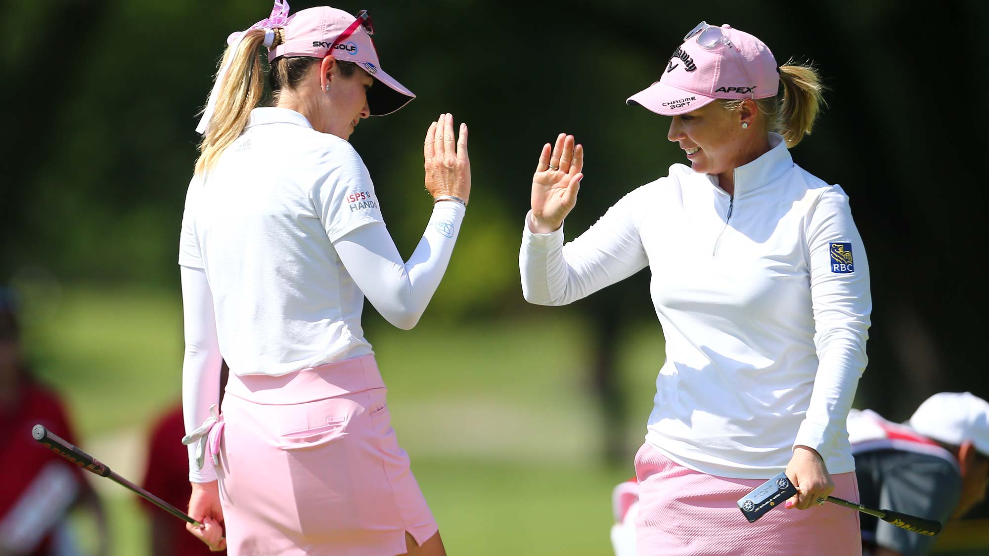 (R-L) Morgan Pressel celebrates her birdie putt with Paula Creamer on the 12th hole during the first round of the Dow Great Lakes Bay Invitational 