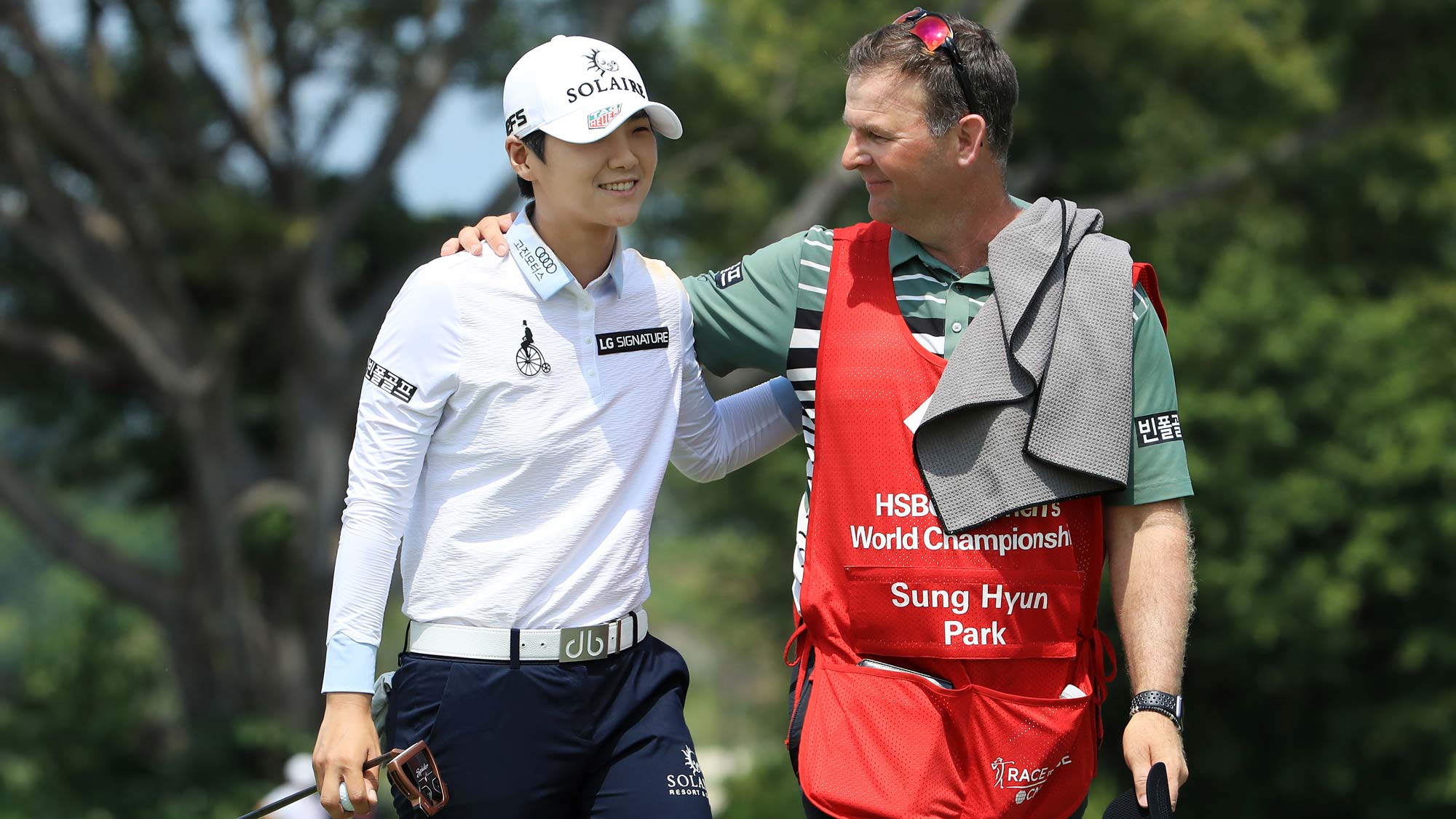 Sung Hyun Park of South Korea and her caddie, David Jones, celebrate after finishing on the 18th green during the final round of the HSBC Women's World Championship