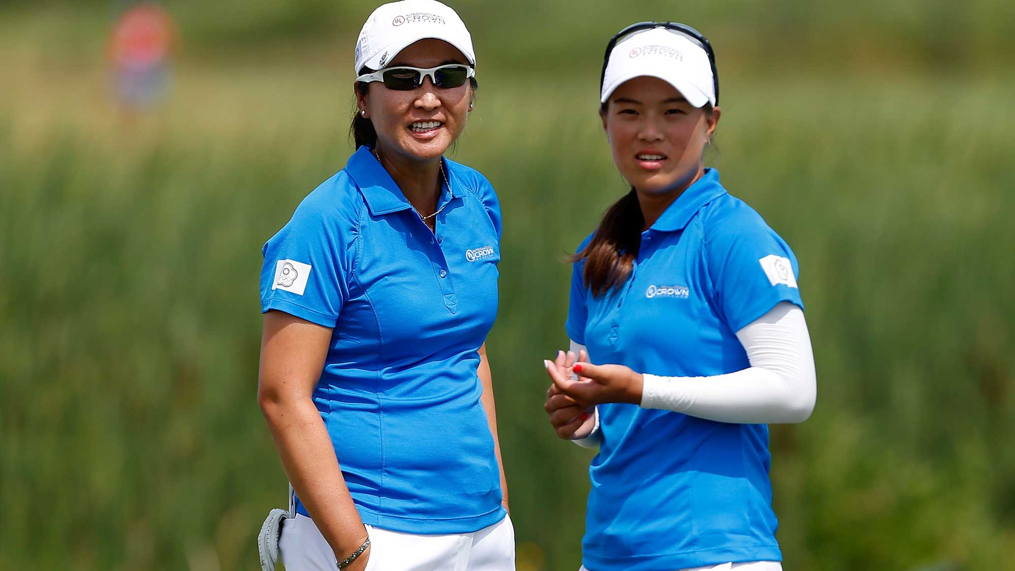 Candie Kung (L) and Ssu-Chia Cheng of Chinese Taipei stand on the fourth green during the four-ball session of the 2016 UL International Crown