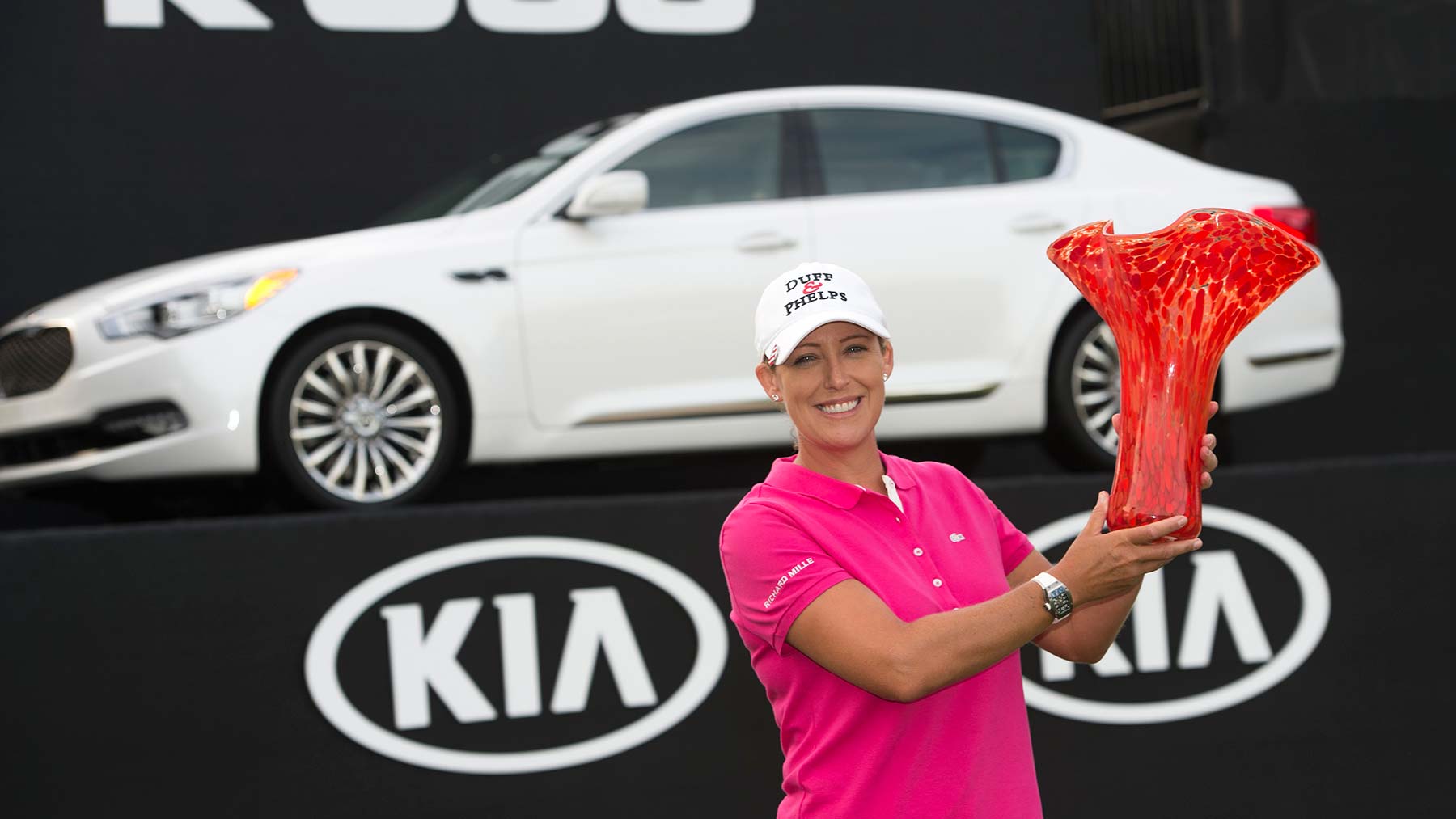 Cristie Kerr with the Kia Classic Trophy in front of the Kia K900