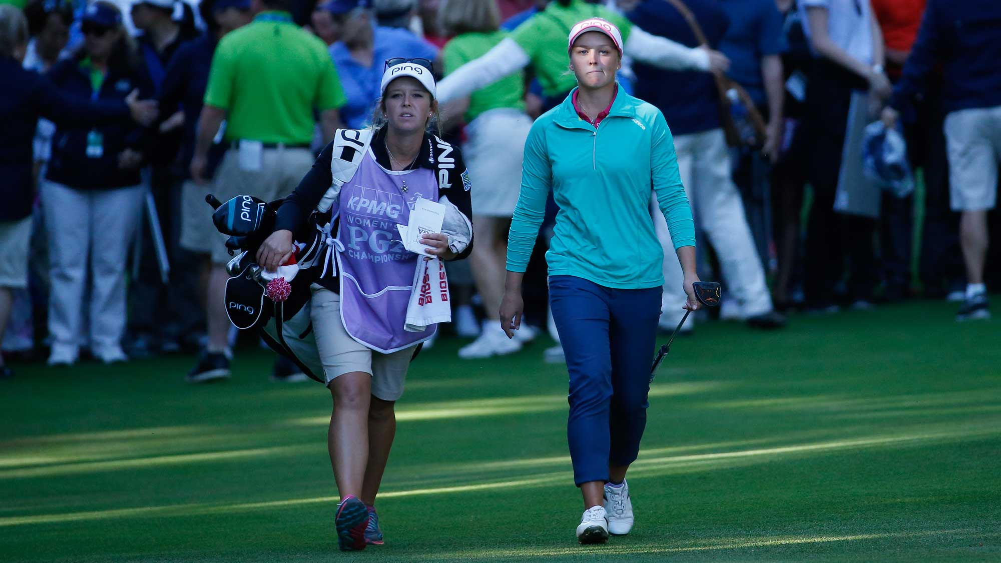 Brooke Henderson (R) of Canada and her caddie sister Brittany, walk up to the 18th green during a shoot-out in the final round of the KPMG Women's PGA Championship