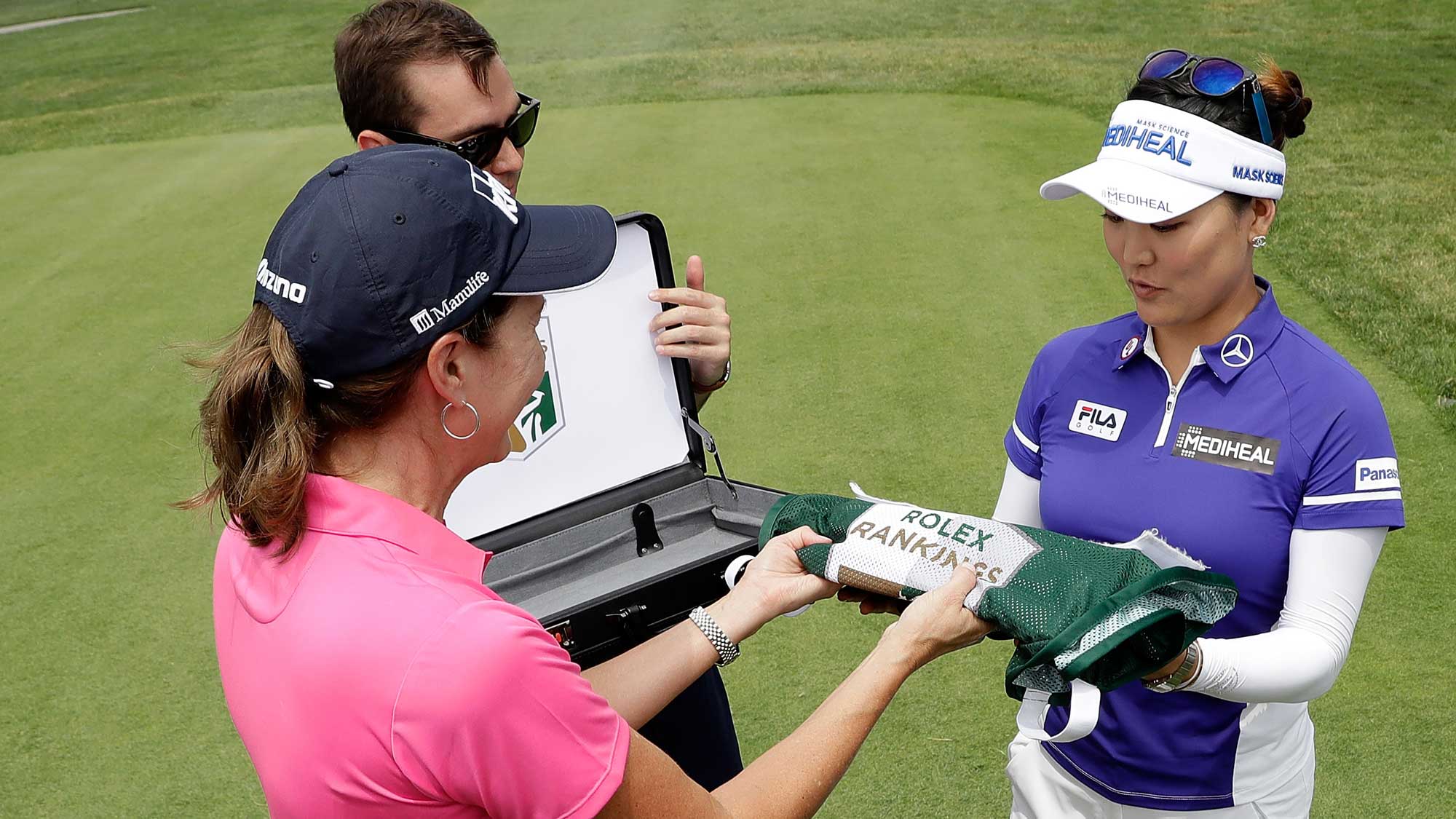 Lynne Doughtie Chairman and CEO of KPMG U.S. presents So Yeon Ryu of South Korea a caddie bib signifying her #1 world ranking during the first round of the 2017 KPMG PGA Championship