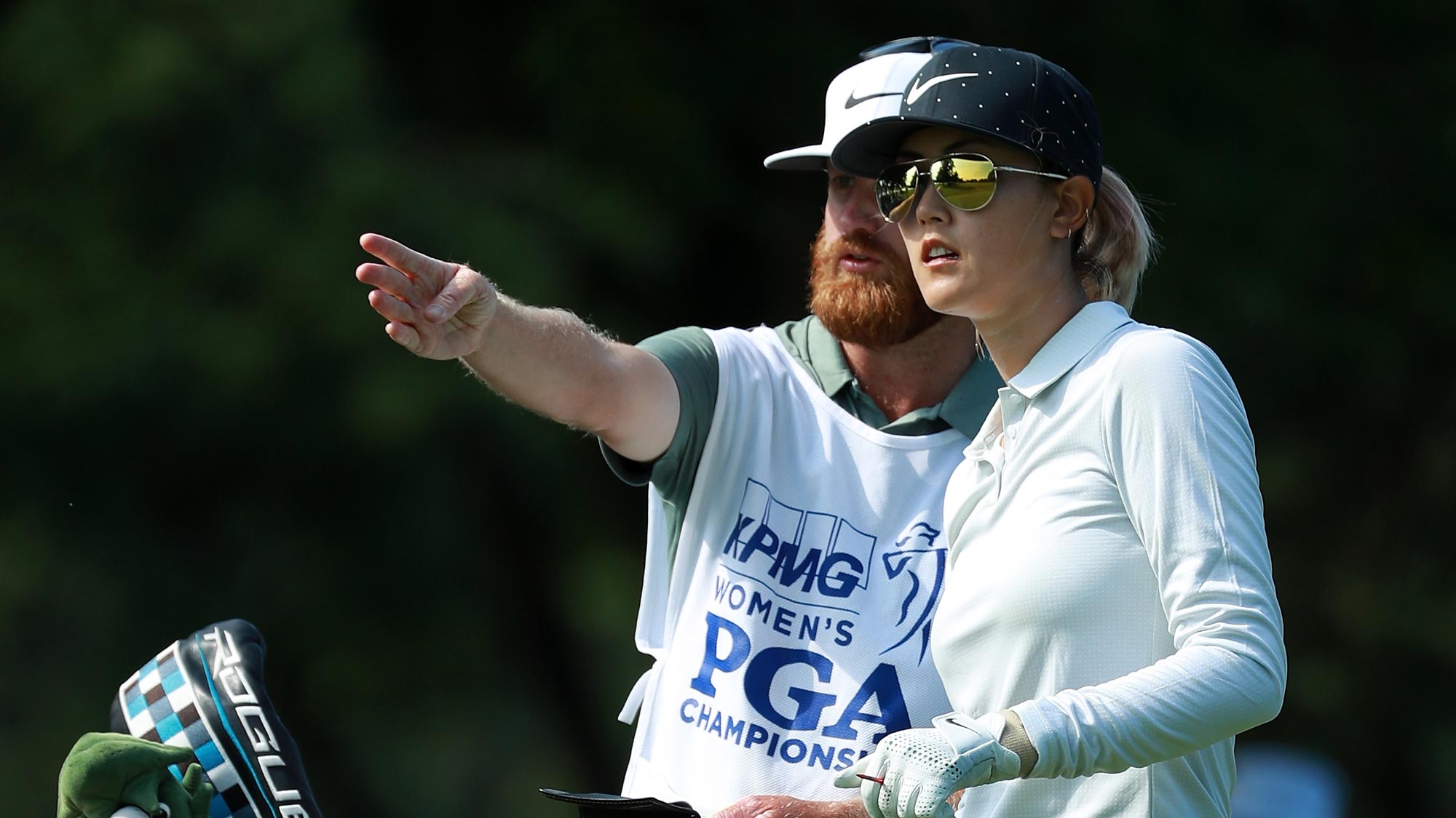 Michelle Wie lines up her tee shot with her caddie on the fifth hole during the first round of the KPMG Women's PGA Championship