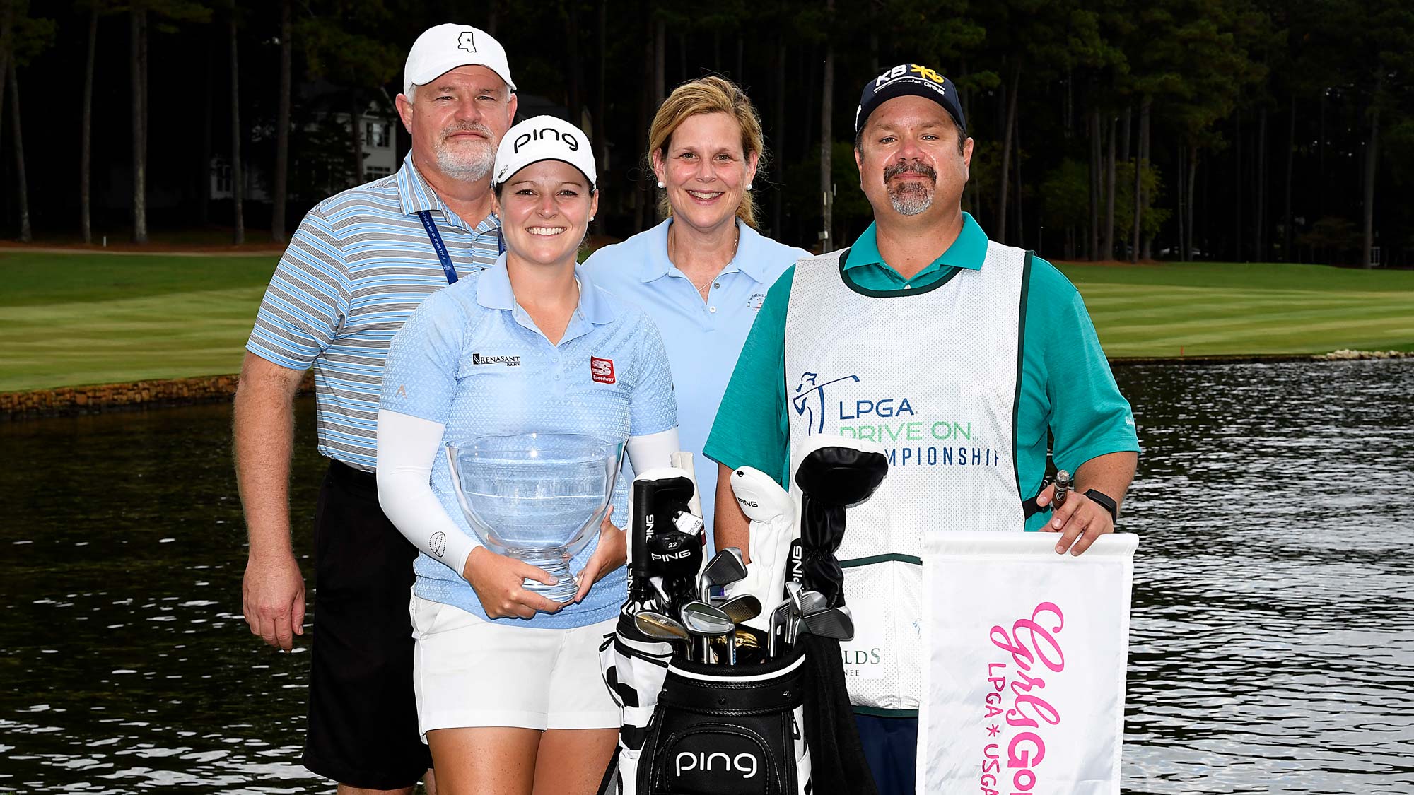 Ally McDonald poses with her parents and caddie as she holds the winner's trophy after winning the 2020 LPGA Drive On Championship at Reynolds Lake Oconee