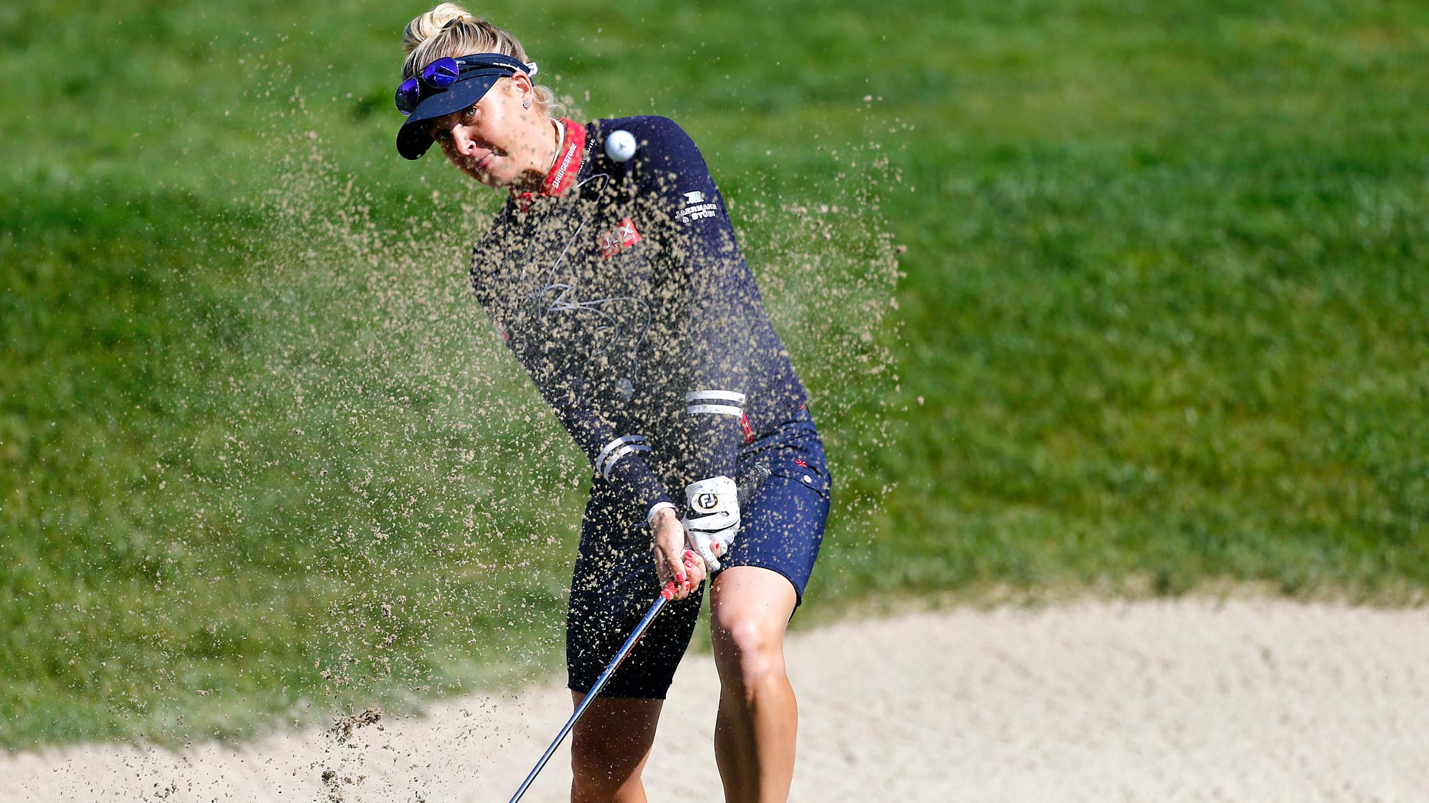 Charley Hull of England hits out of the bunker on the 18th hole during the first round of the LPGA Mediheal Championship