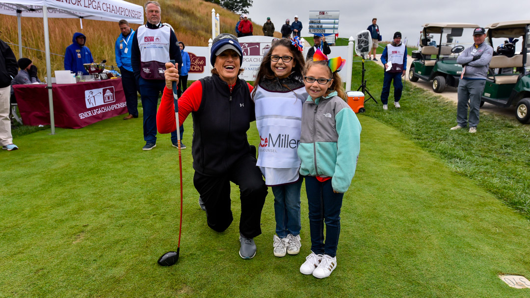 Juli Inkster poses with Brylee Holguin (center) of the Riley's Kids progam and her sister on the first tee of the Senior LPGA Championship