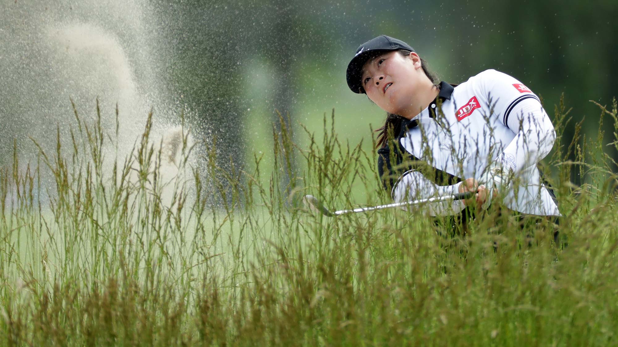 Angel Yin plays from a bunker on the fifth hole during the first round of the ShopRite LPGA Classic presented by Acer