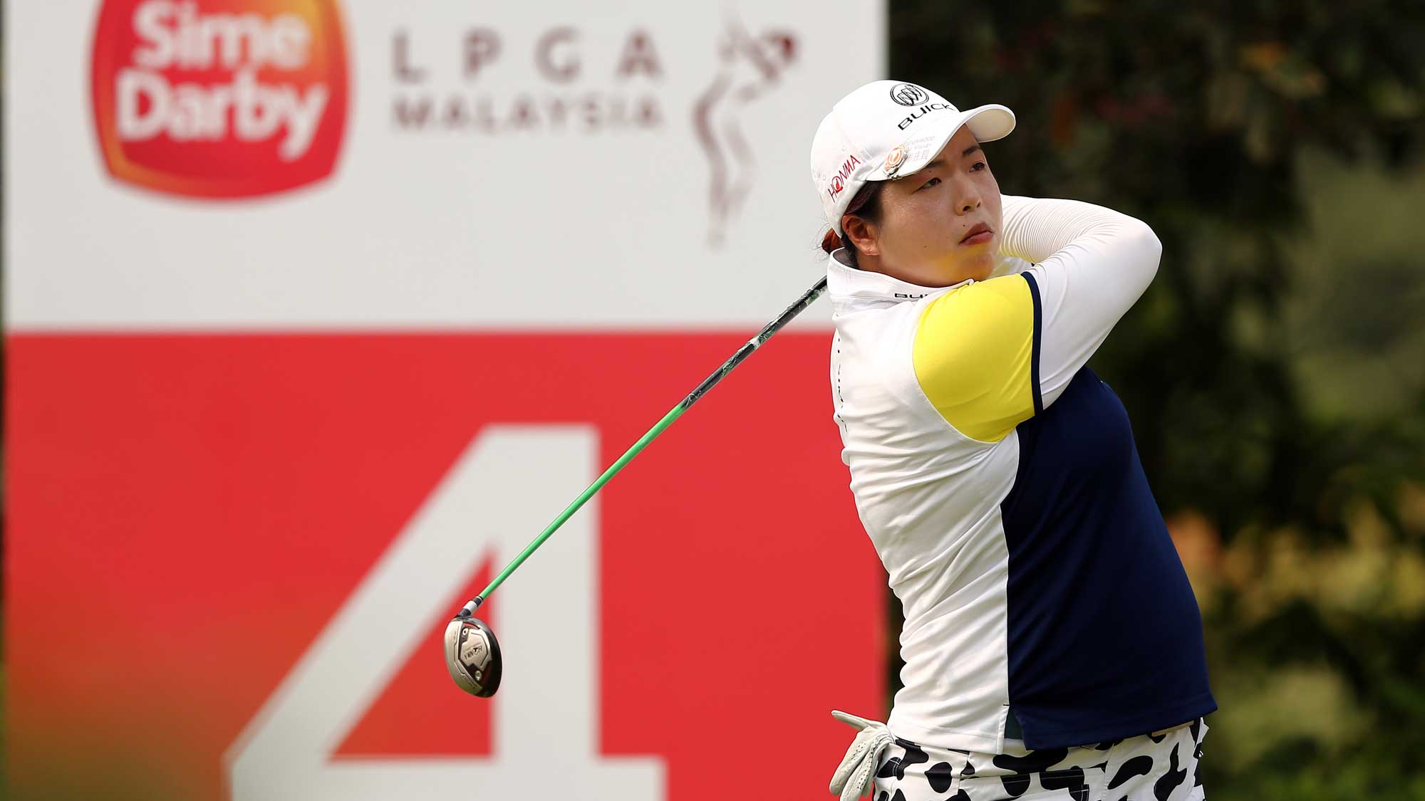 Shanshan Feng of China watches her tee shot on the 4th hole during round three of the Sime Darby LPGA Tour at Kuala Lumpur Golf & Country Club