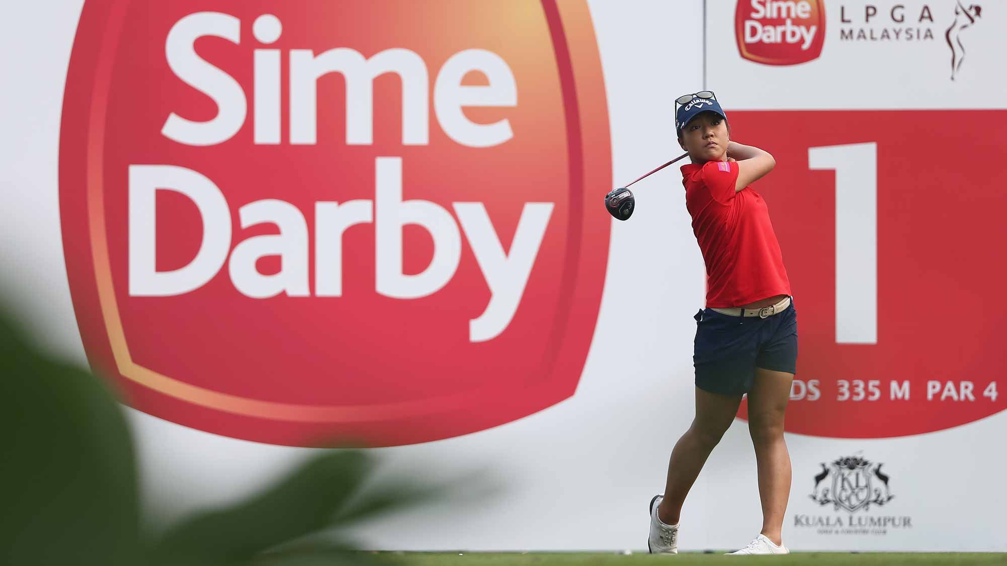 Lydia Ko of New Zealand watches her tee shot on the 1st hole during the final round of the Sime Darby LPGA Tour at Kuala Lumpur Golf & Country Club