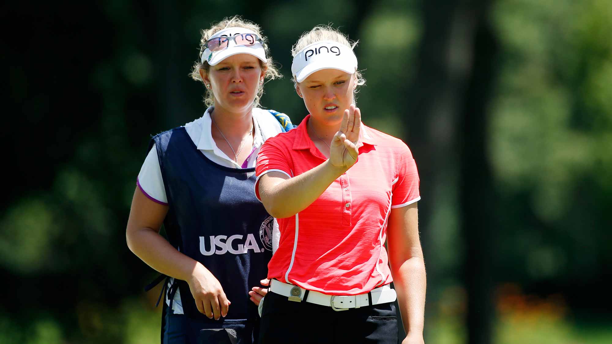 Brooke Henderson of Canada lines up a putt with her sisiter/caddie Brittany on the 16th green during the second round of the U.S. Women's Open at Lancaster Country Club