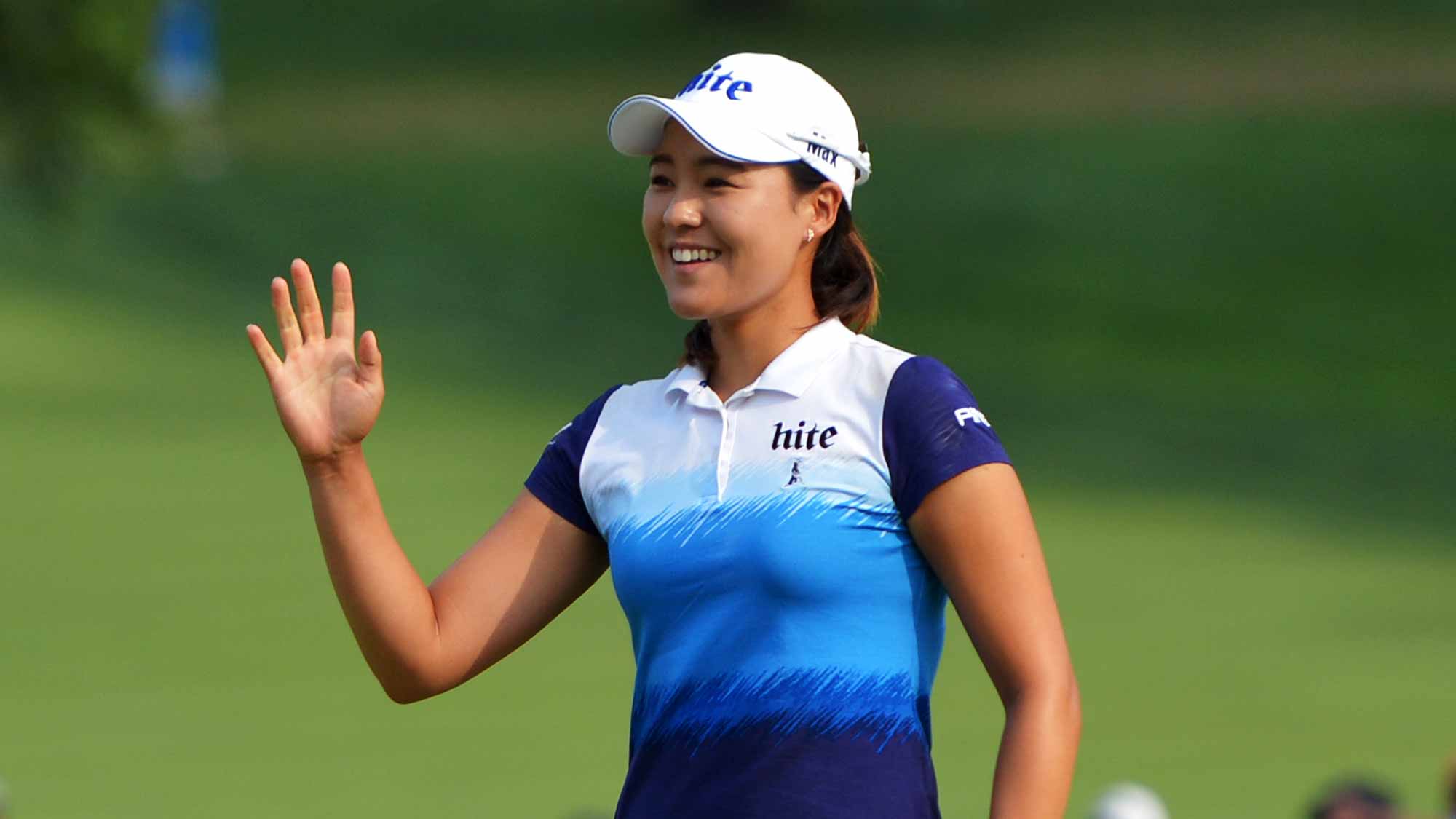 In Gee Chun of South Korea waves to the gallery after making birdie on the 16th hole during the final round of the U.S. Women's Open at Lancaster Country Club