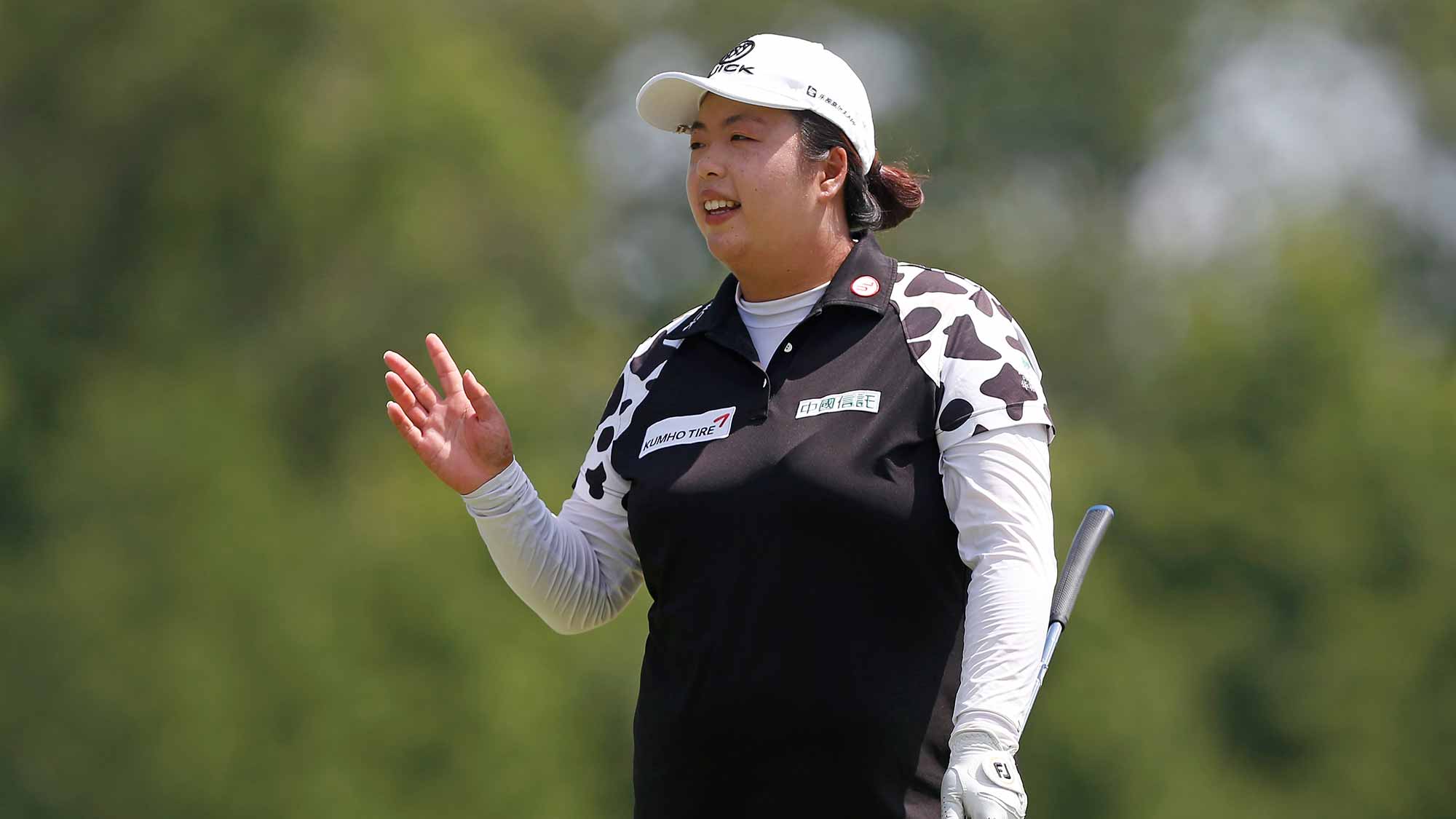 Shanshan Feng of China reacts after making a putt on the first hole during the final round of the U.S. Women's Open Championship at Trump National Golf Club