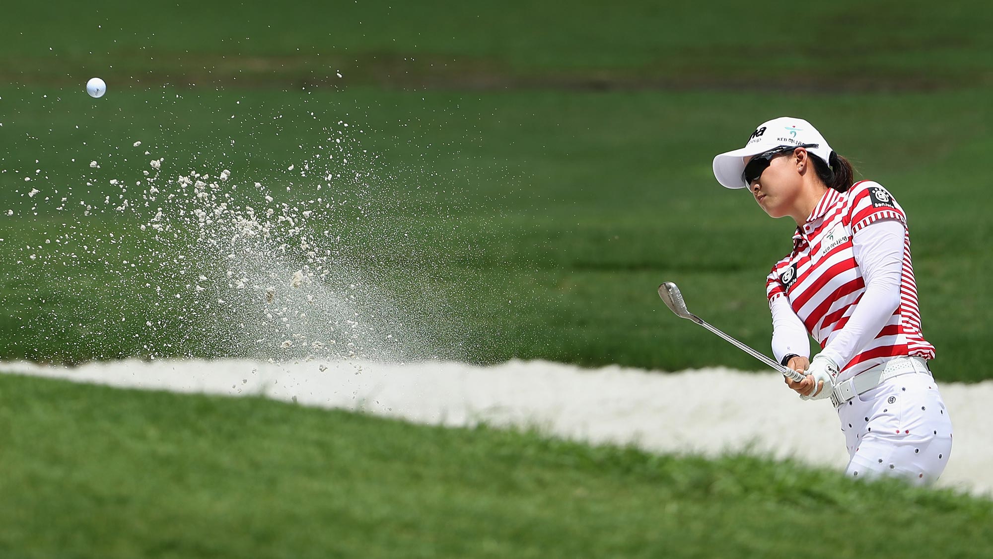 Minjee Lee of Australia chips from the bunker onto the first green during the thrid round of the 2018 U.S. Women's Open