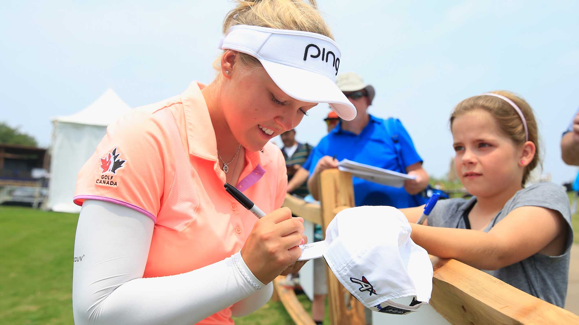 Brooke M. Henderson of Canada signs an autograph for a fan during the second round of the Volunteers of America Texas Shootout