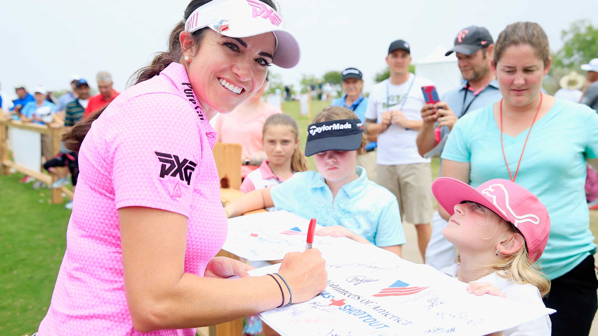 Gerina Piller poses as she signs an autograph for a fan after finishing with a six-under par 65 during the second round of the Volunteers of America Texas Shootout