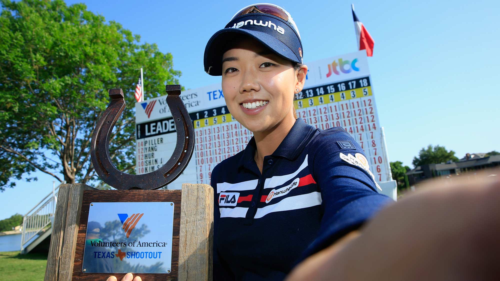 Jenny Shin poses for a simulated 'Selfie' with the trophy after her two-stroke victory at the Volunteers of America Texas Shootout