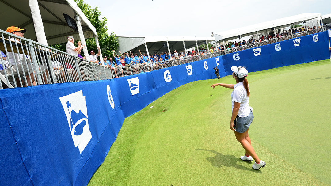 Lydia Ko throws a golf ball into the crowd at the Gatorade Loudest Hole on Tour