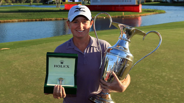 Stacy Lewis holds trophy and Rolex First Time Winner watch.
