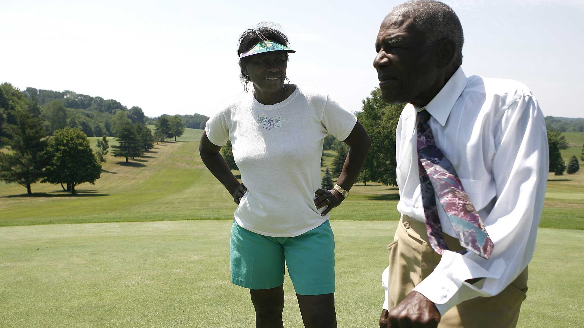 Bill Powell and his daughter Renee Powell talk on a green at Clearview Golf Club on June 25, 2009 in East Canton, Ohio.