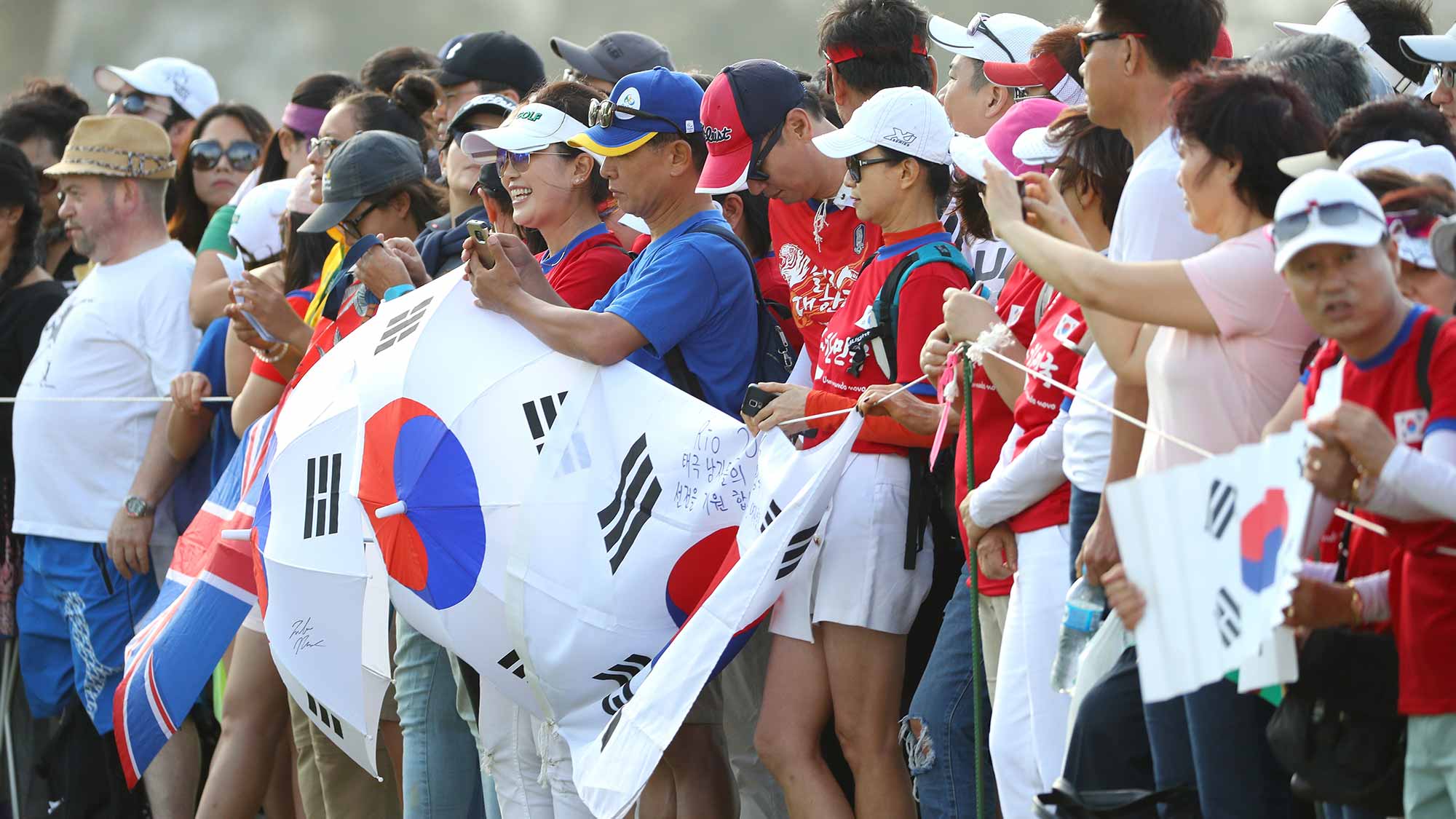  Fans of Korea look on over the first tee during the Women's Golf Final on Day 15 of the Rio 2016 Olympic Games at the Olympic Golf Course