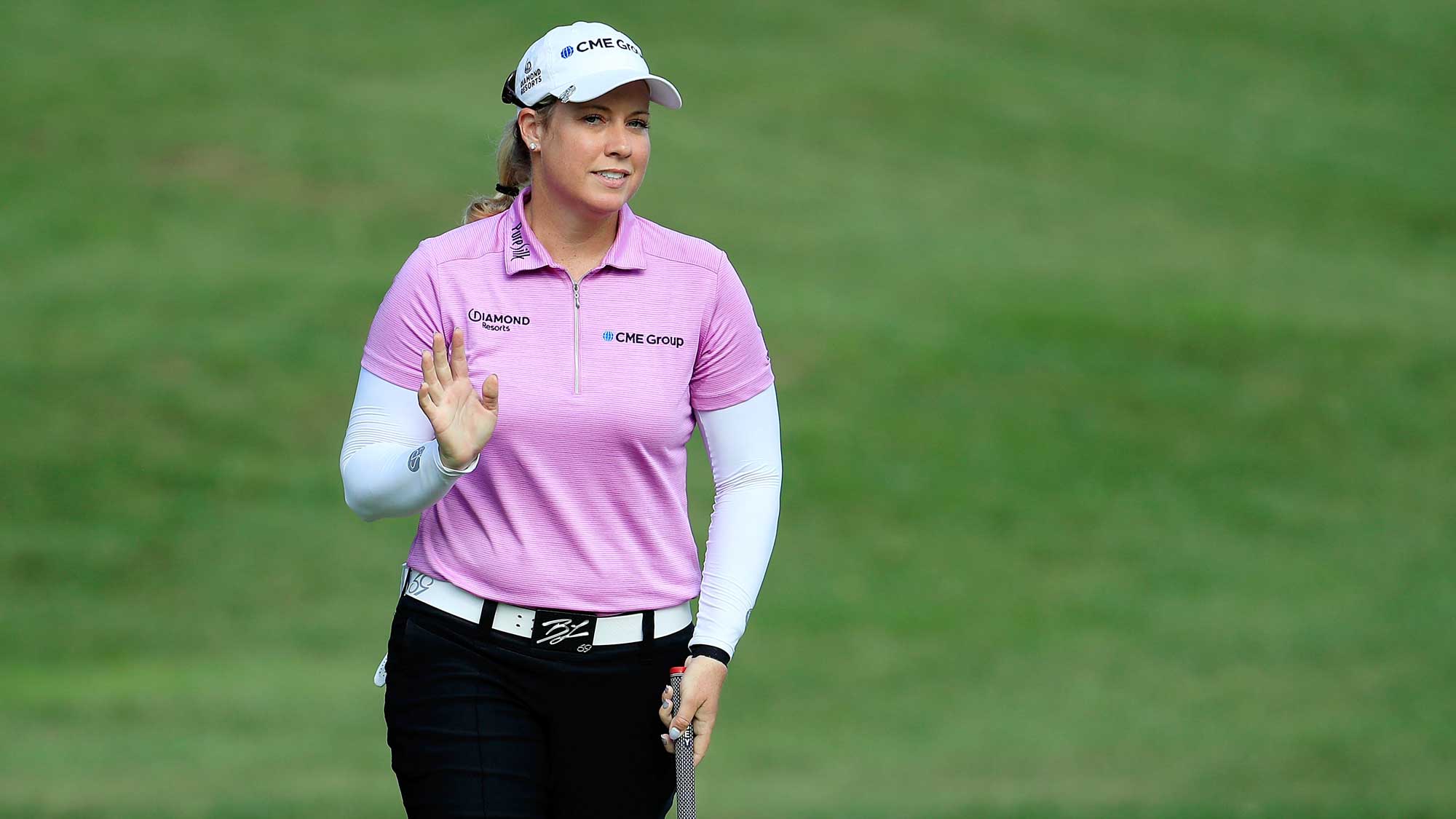 Brittany Lincicome waves to the crowd following a birdie on the seventh hole during a continuation of the second round of the Barbasol Championship