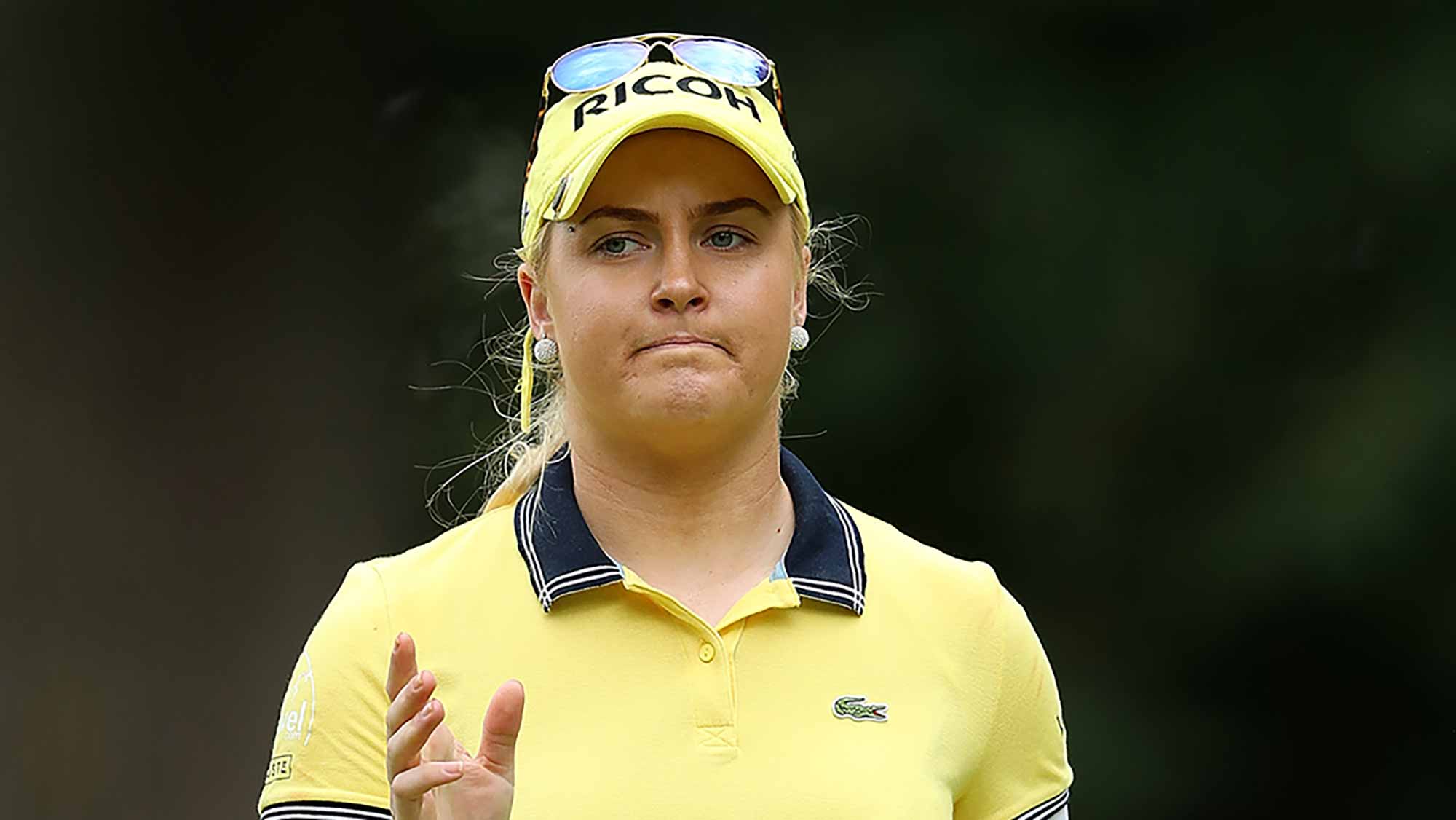Charley Hull of England acknowledges the crowd on the 1st green during the third round of the Ricoh Women's British Open at Woburn Golf Club