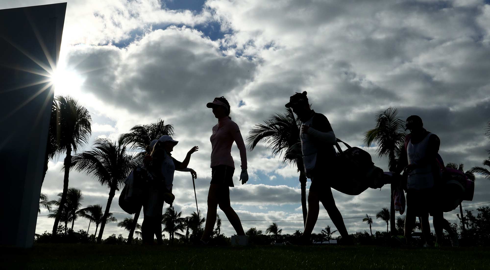Katie Burnett of the United States, Brittany Lang of the United States and Sandra Gal of Germany prepare to tee off on the fourth hole during round one of the Pure Silk Bahamas LPGA Classic