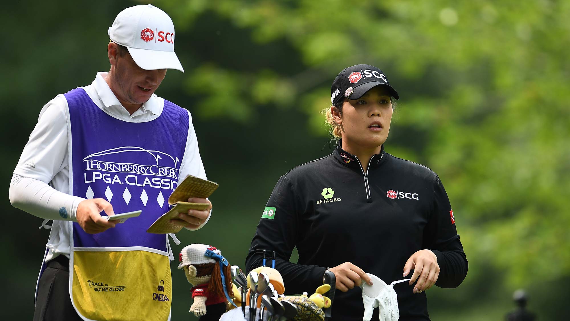 Ariya Jutanugarn of Thailand speaks with her caddie on the second tee during the final round of the Thornberry Creek LPGA Classic