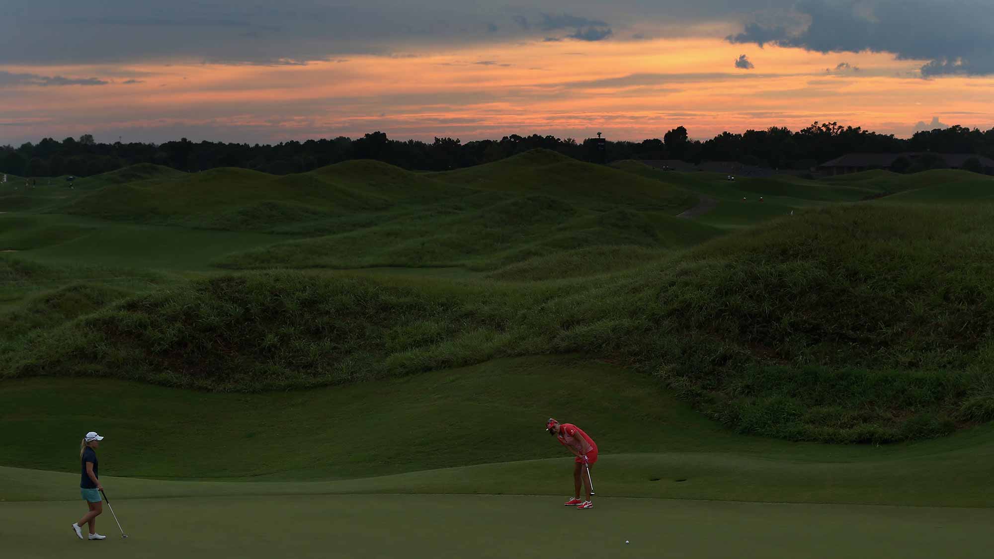 Lexi Thompson (R) putts on the 3rd hole as Austin Ernst (L) looks on during the third round of the Yokohama Tire LPGA Classic at the Robert Trent Jones Golf Trail at Capitol Hill