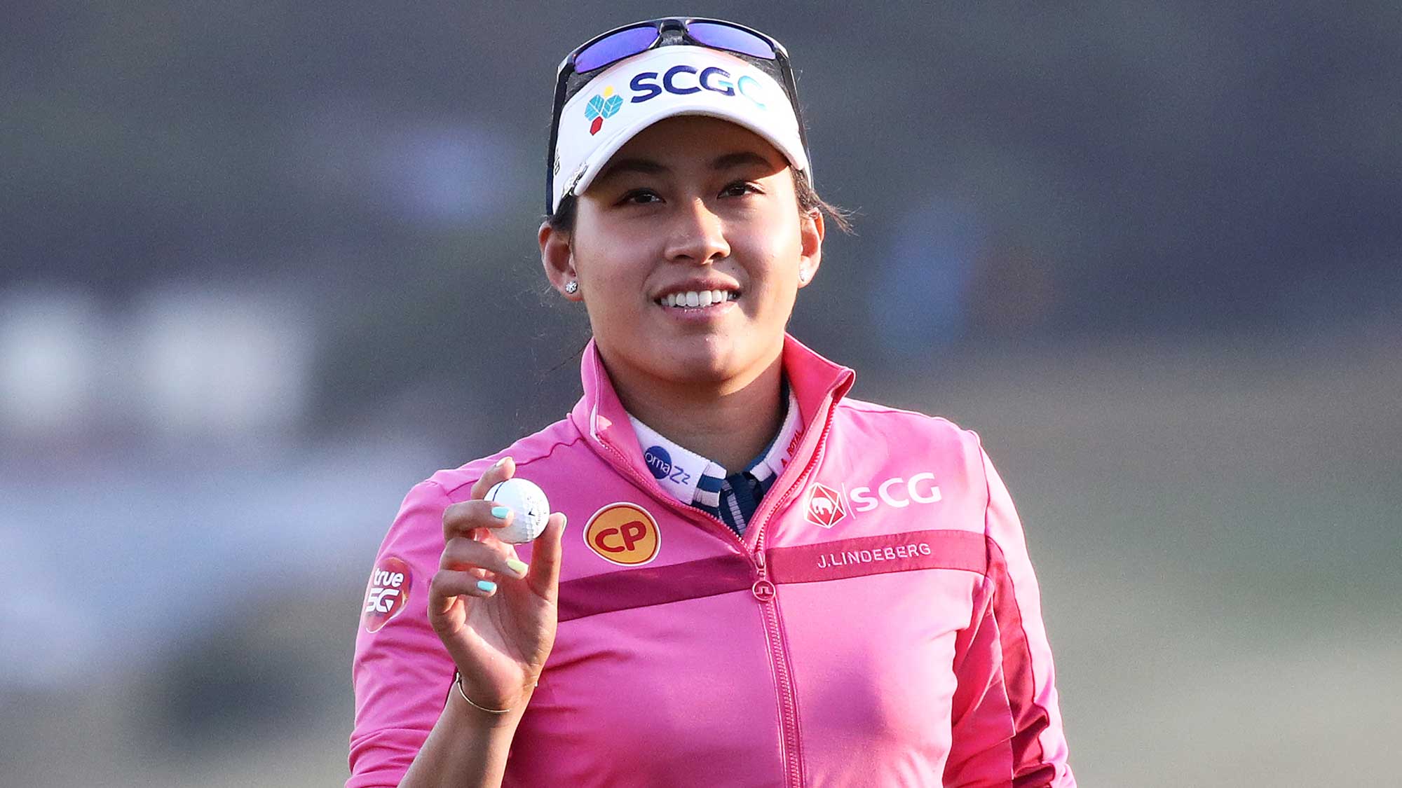 Atthaya Thitikul of Thailand reacts after sinking her putt on the 18th green during the first round of the BMW Ladies Championship 