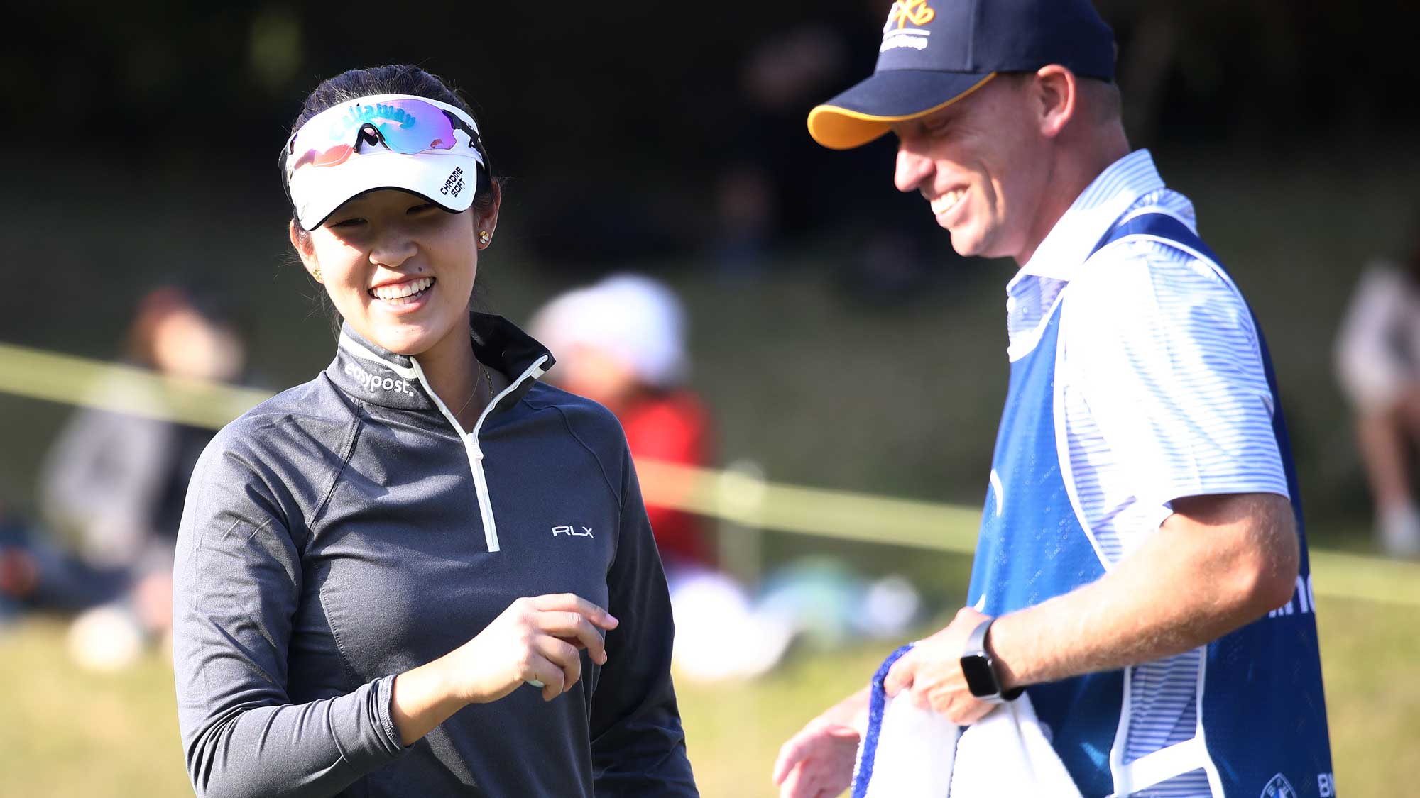 Andrea Lee of the United States reacts with her caddie after sinking her putt on the 17th green during the second round of the BMW Ladies Championship 