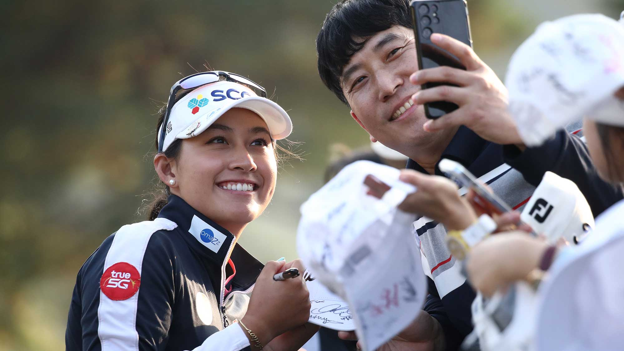 Atthaya Thitikul of Thailand poses for photos with fans after finishing the third round of the BMW Ladies Championship