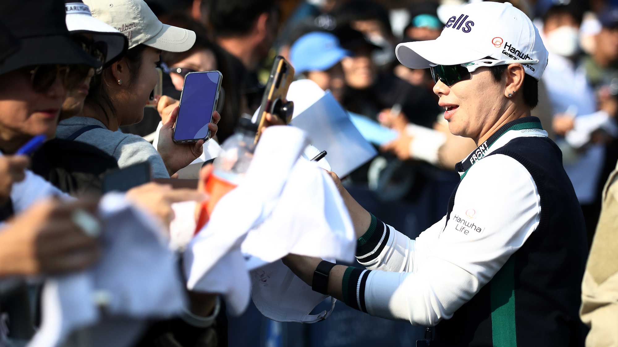 Eun-Hee Ji of South Korea signs autographs for fans during the third round of the BMW Ladies Championship