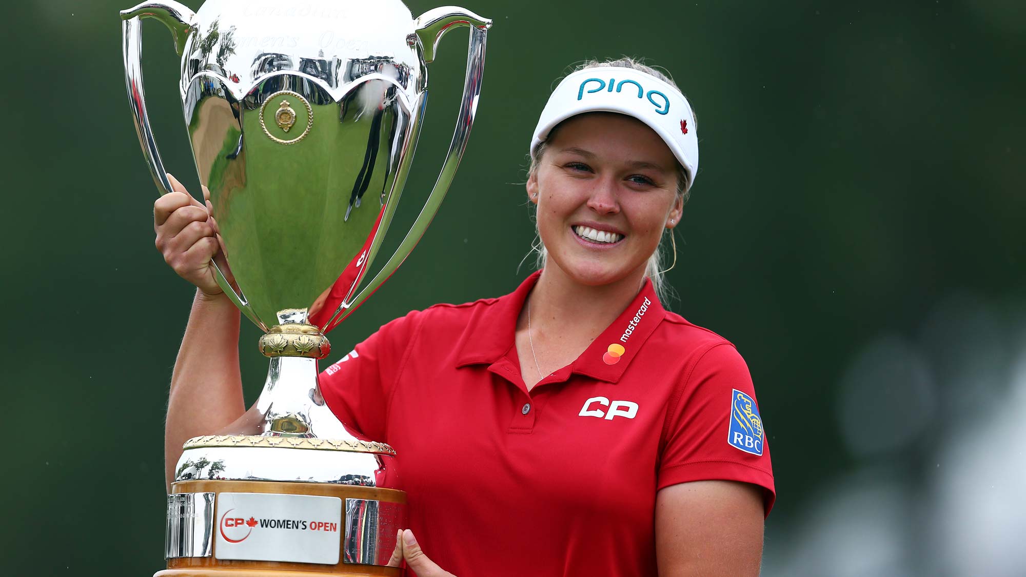Brooke Henderson of Canada lifts the champions trophy following the final round of the CP Womens Open